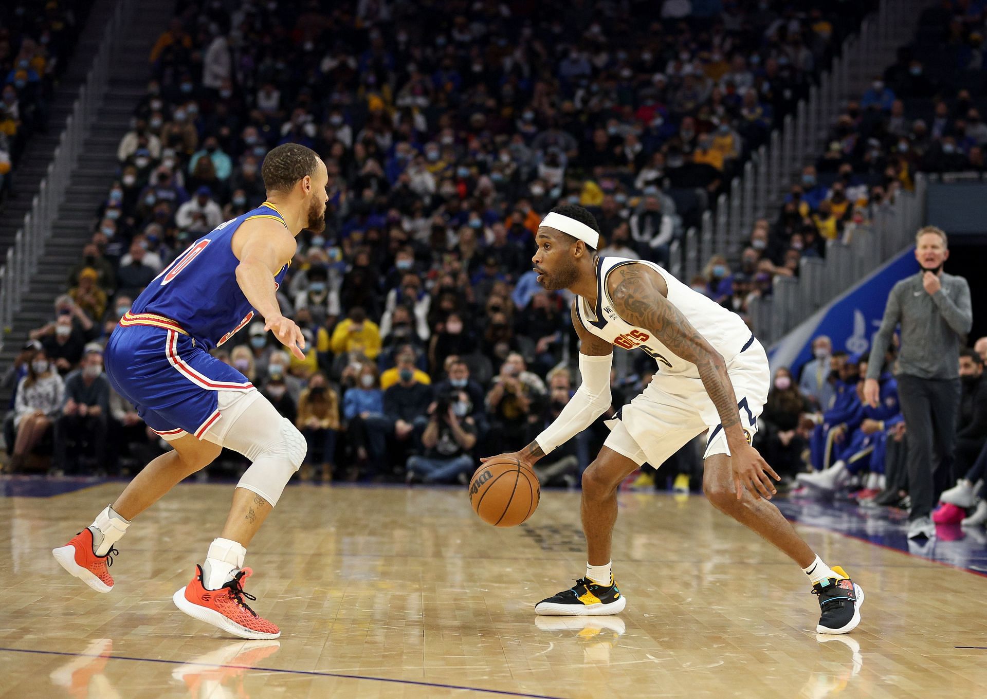Will Barton of the Nuggets guarded by Steph Curry