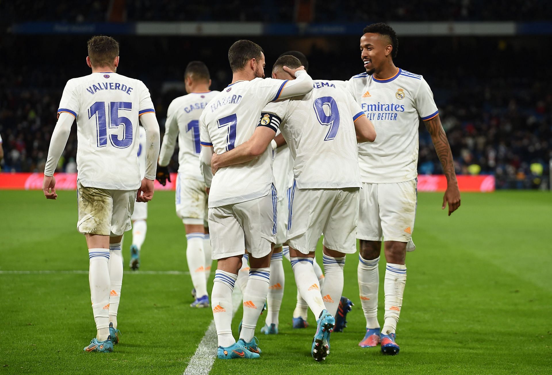 Real Madrid players celebrate after scoring a goal.