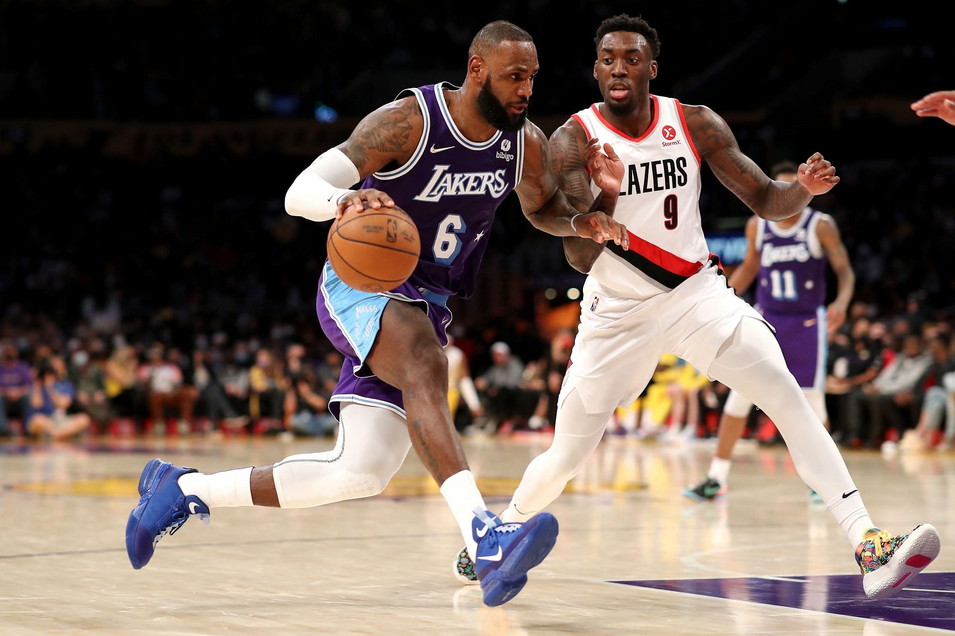 LeBron James of the LA Lakers drives against Nassir Little of the Portland Trail Blazers