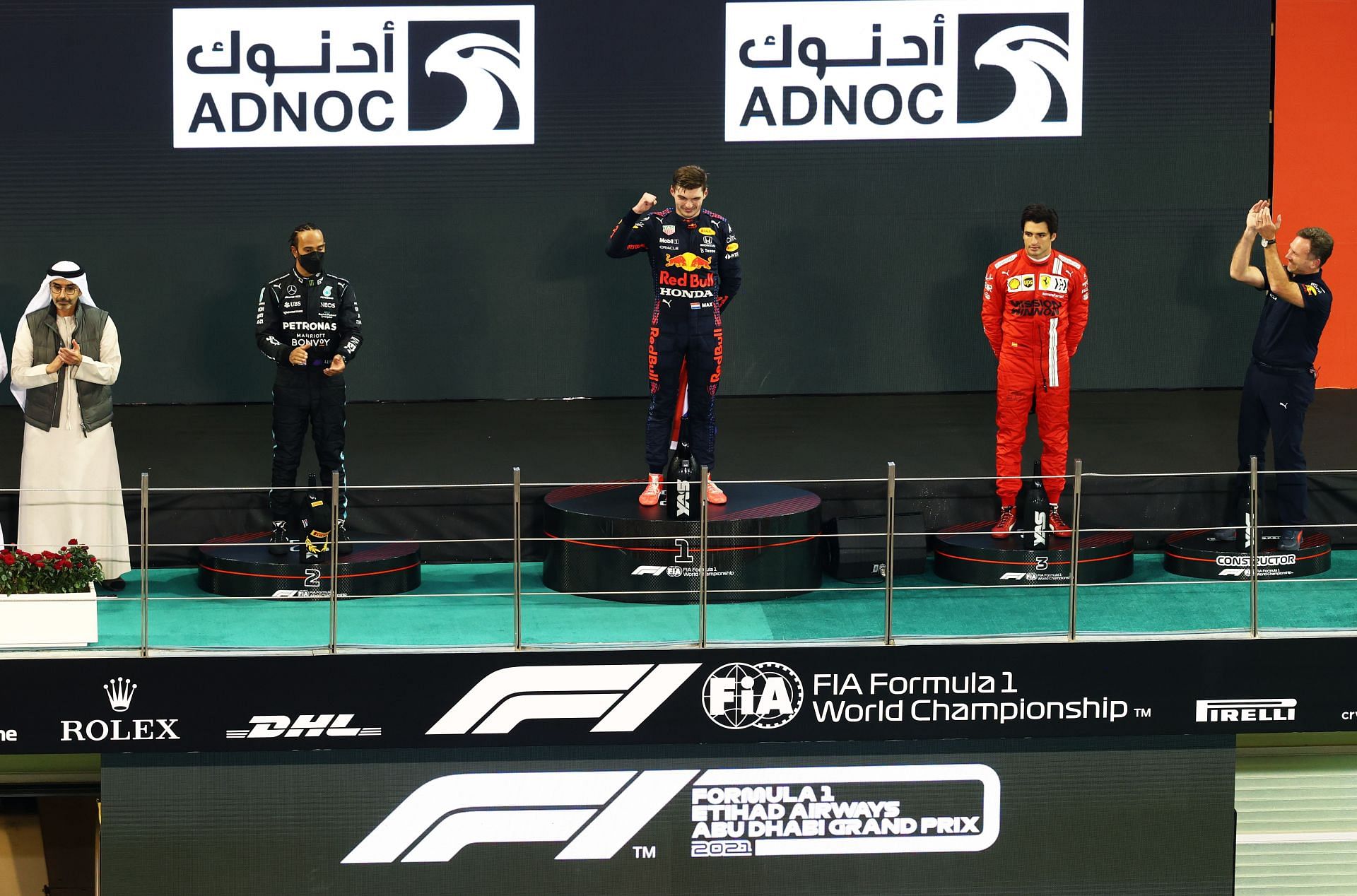 Lewis Hamilton and Carlos Sainz flank Max Verstappen on the 2021 Abu Dhabi GP podium (Photo by Clive Rose/Getty Images)