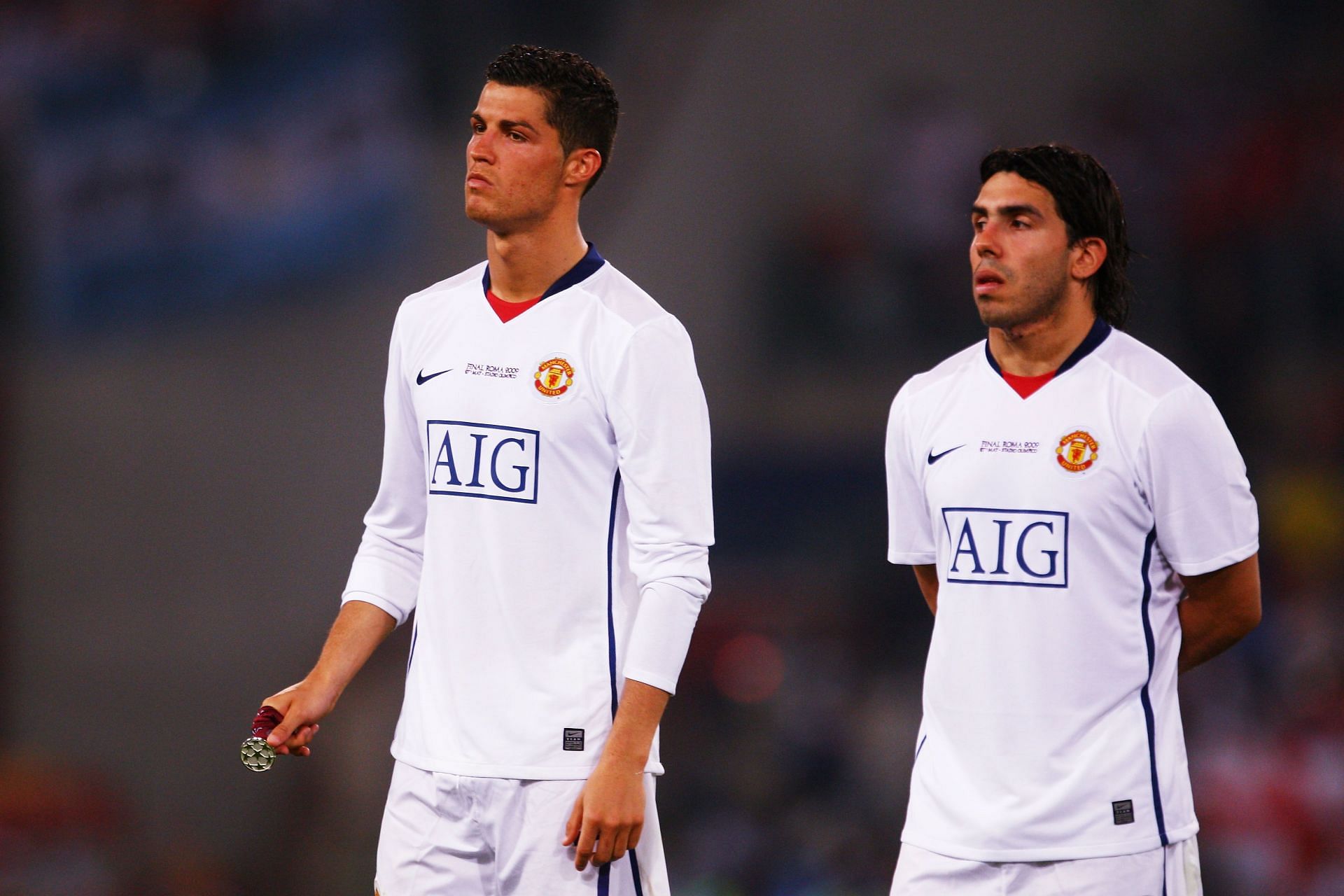 Cristiano Ronaldo (left) and Carlos Tevez (right) in Manchester United colours.