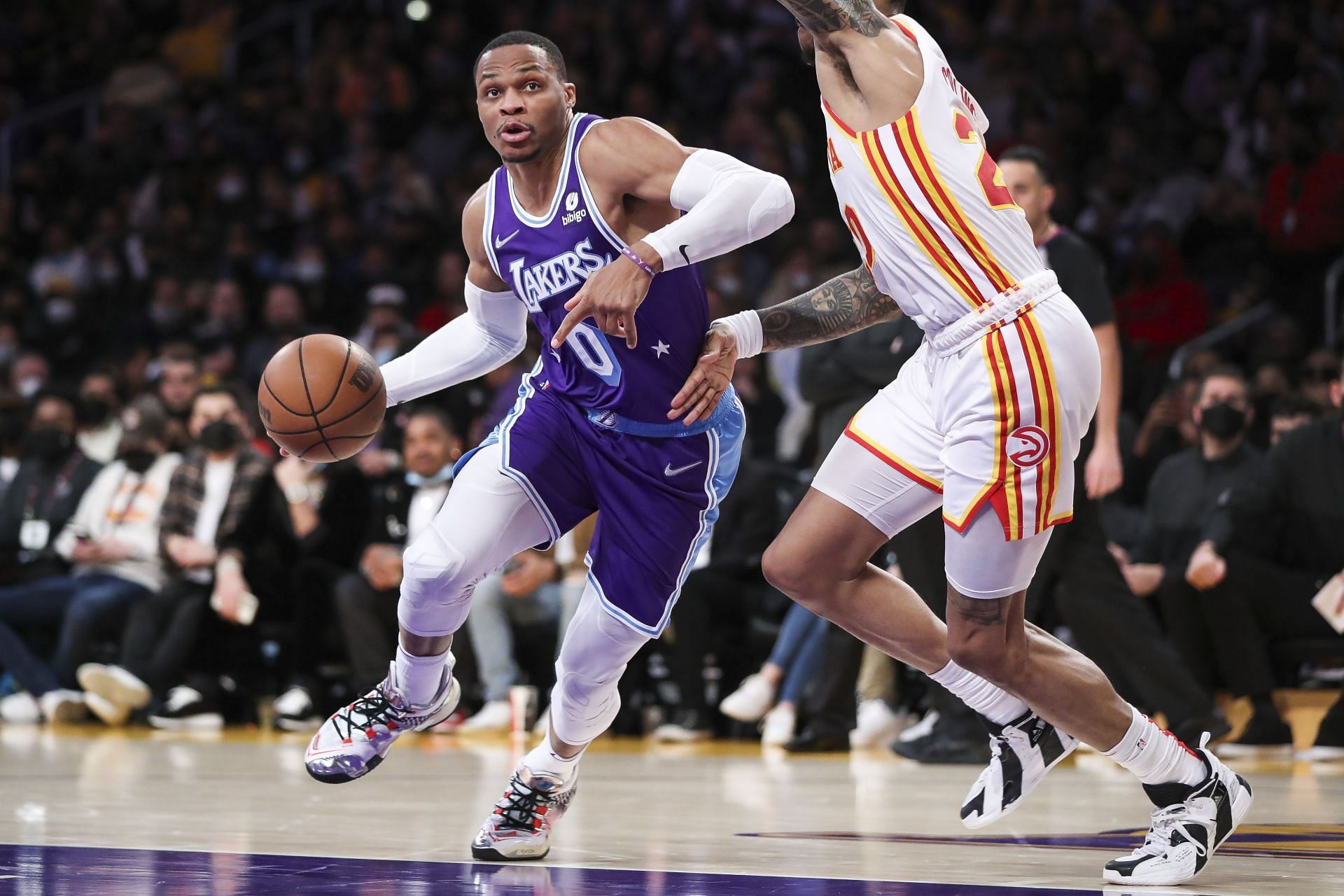 Russell Westbrook #0 of the Los Angeles Lakers handles the ball defended by John Collins #20 of the Atlanta Hawks in the second half at Crypto.com Arena on January 07, 2022 in Los Angeles, California.