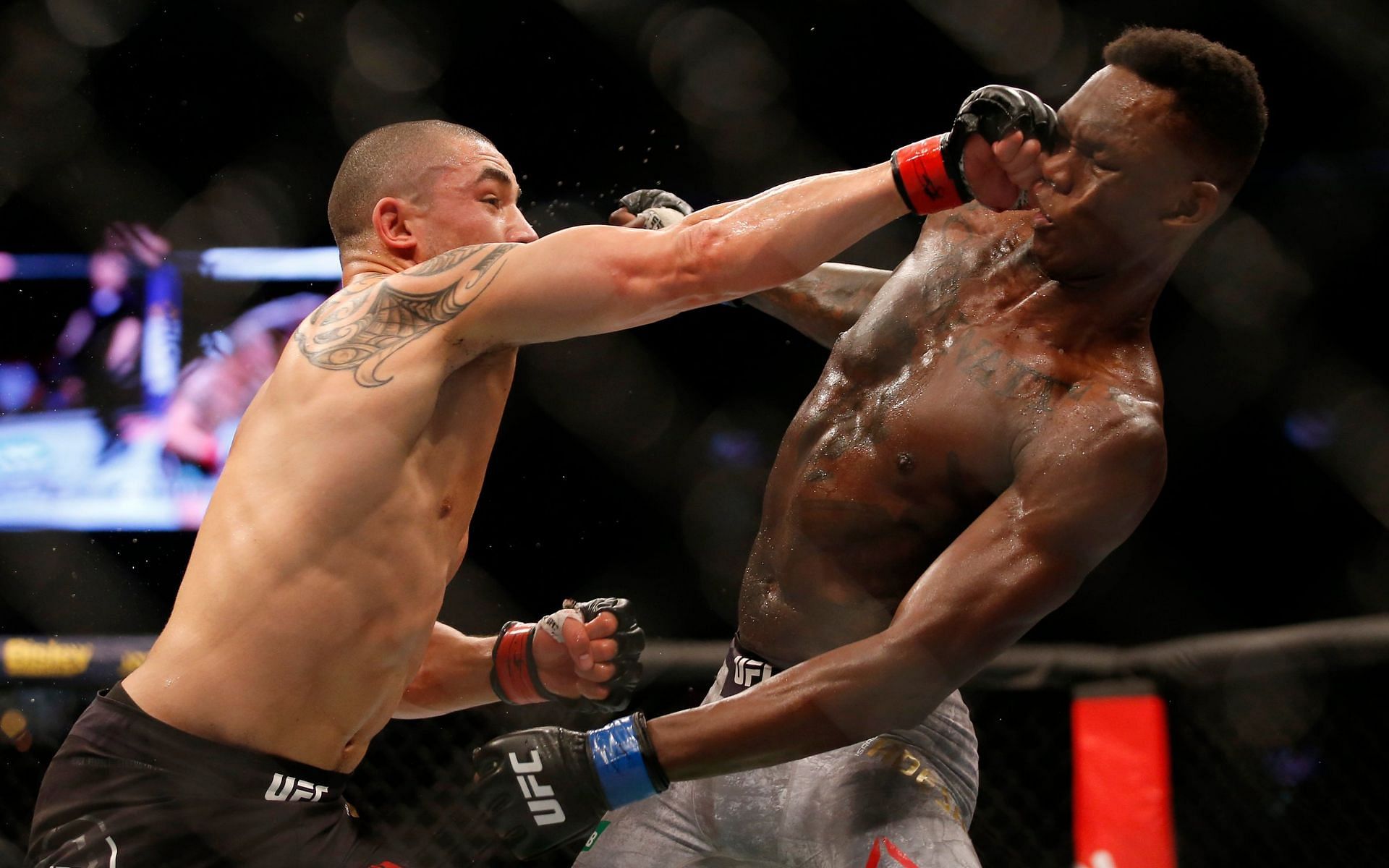 Robert Whittaker (left) in action against Israel Adesanya (right) during their first fight at UFC 243