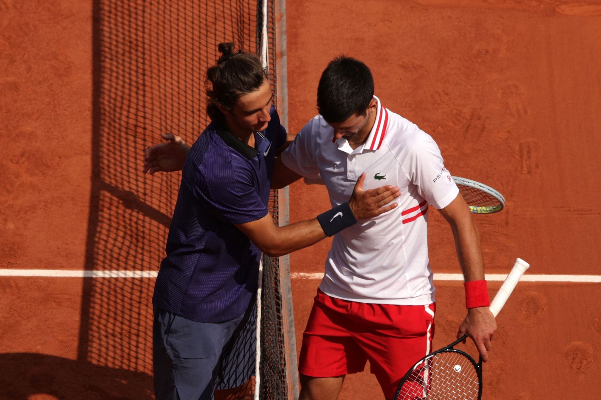 Novak Djokovic and Lorenzo Musetti at the 2021 French Open.