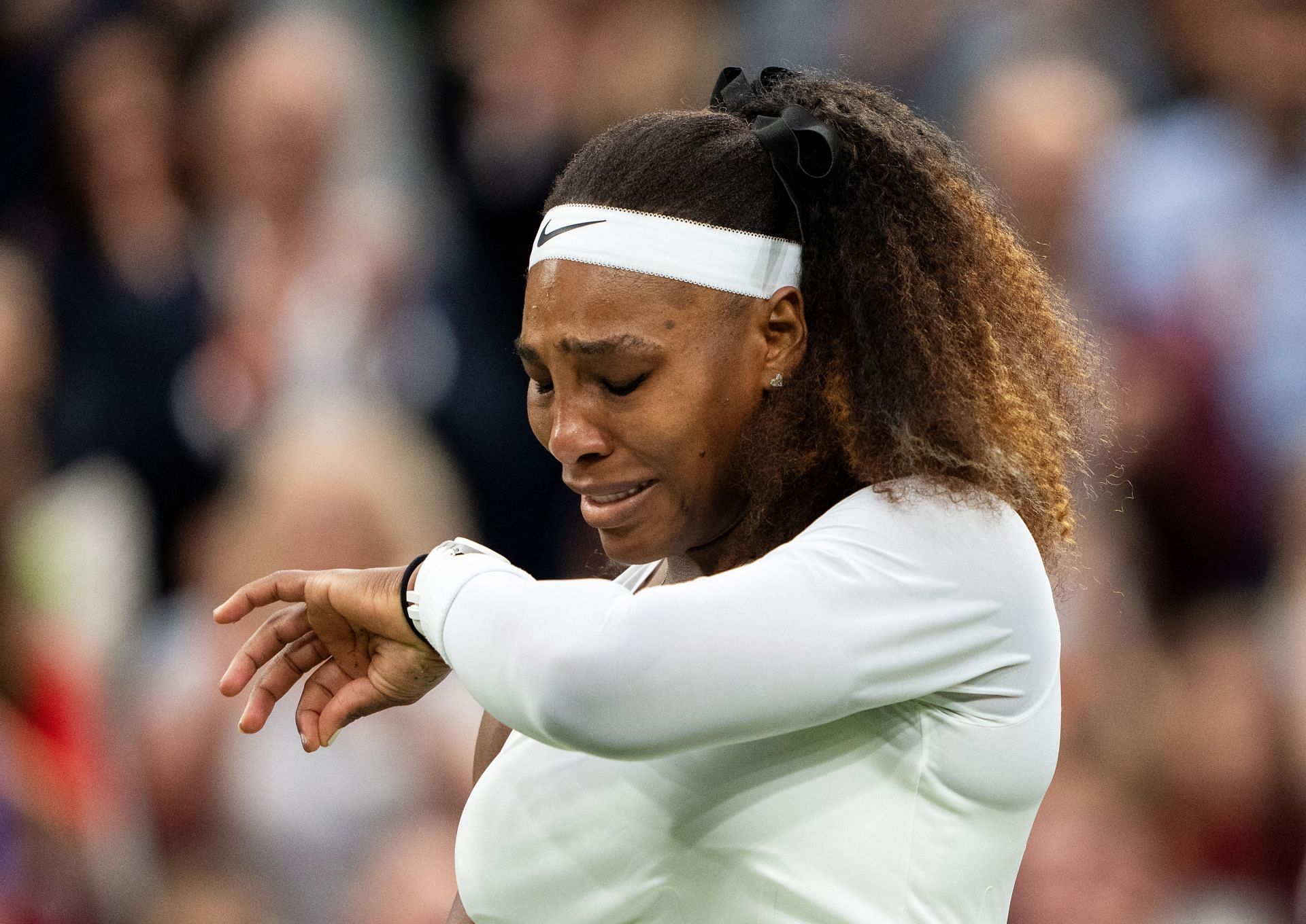 The 40-year-old reacts after retiring from her first-round match at Wimbledon due to a hamstring injury