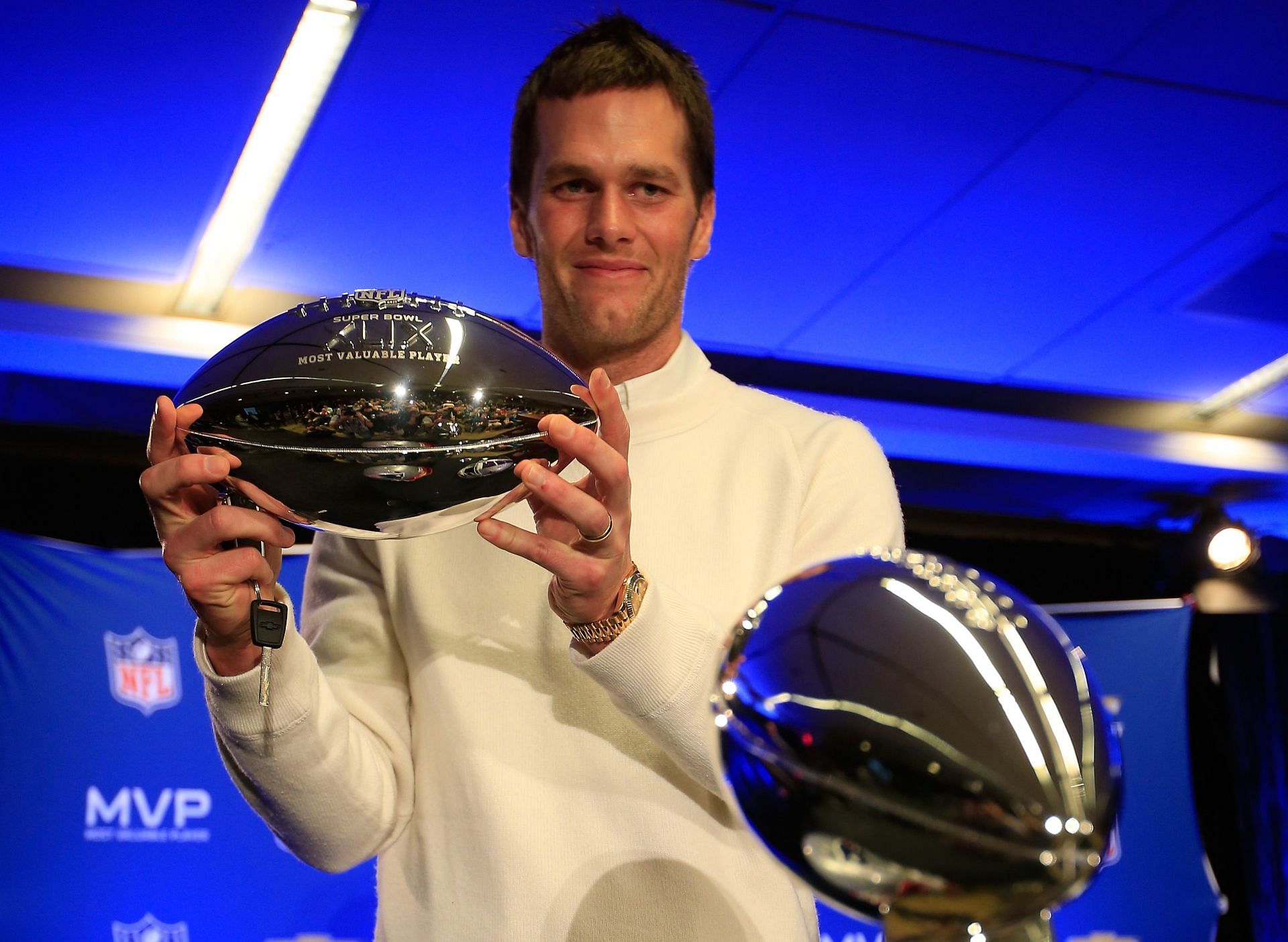 Tom Brady lifting the Super Bowl MVP trophy