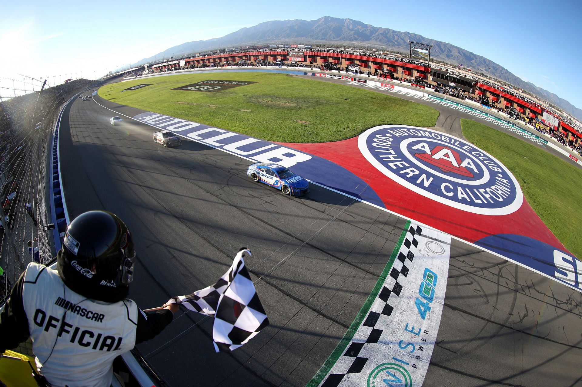 Kyle Larson takes the checkered flag to win the WISE Power 400 (Photo by Meg Oliphant/Getty Images)