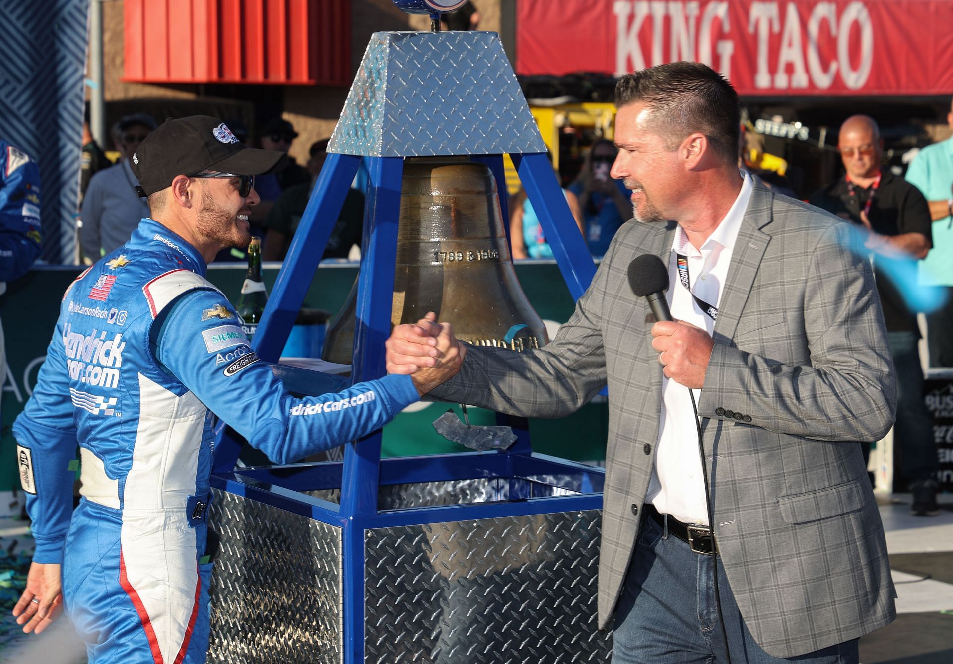 Kyle Larson is congratulated by Dave Allen, President of the Auto Club Speedway, after the former&#039;s victory at the NASCAR Cup Series WISE Power 400