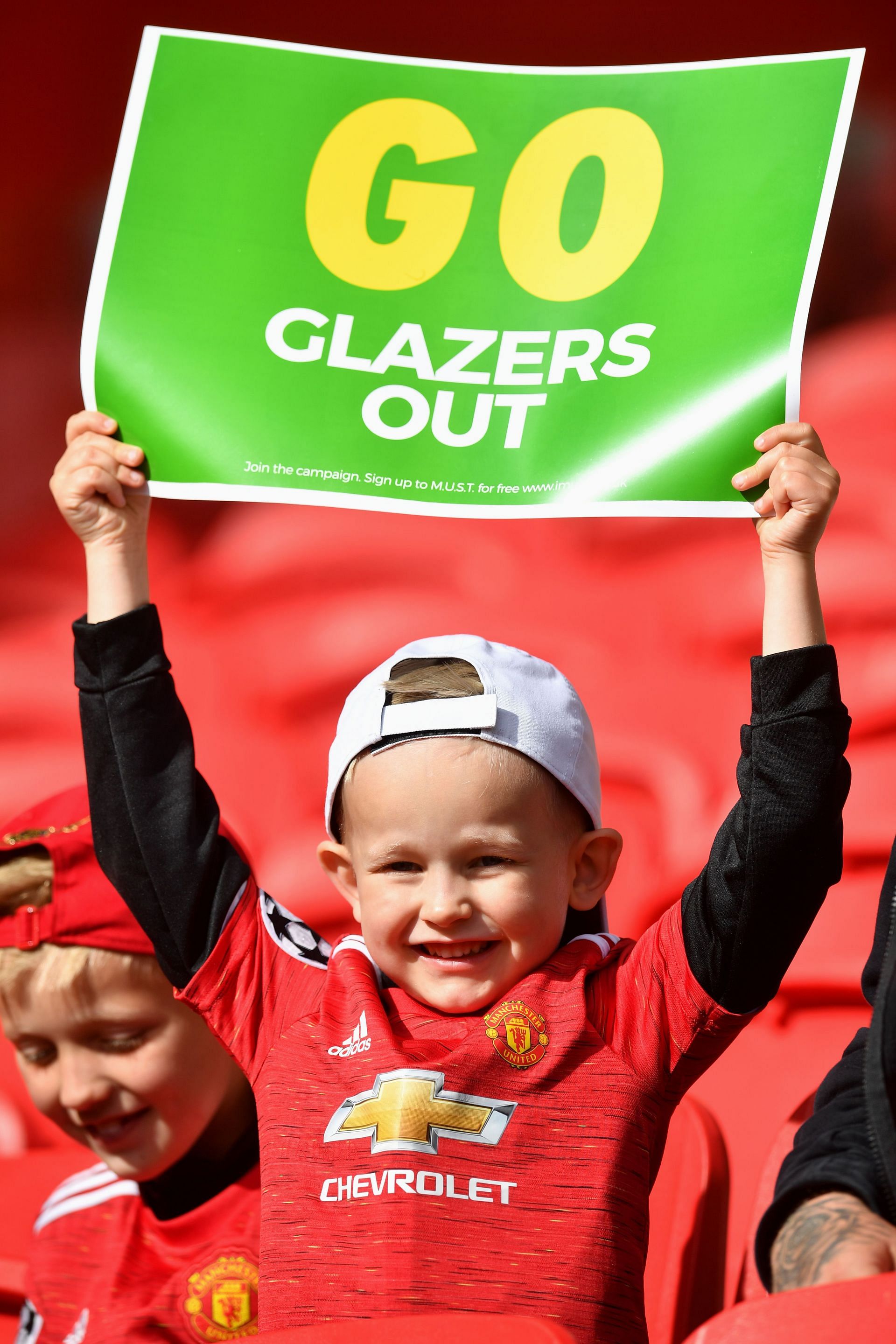 A young fan showing his disapproval of his club&#039;s owners