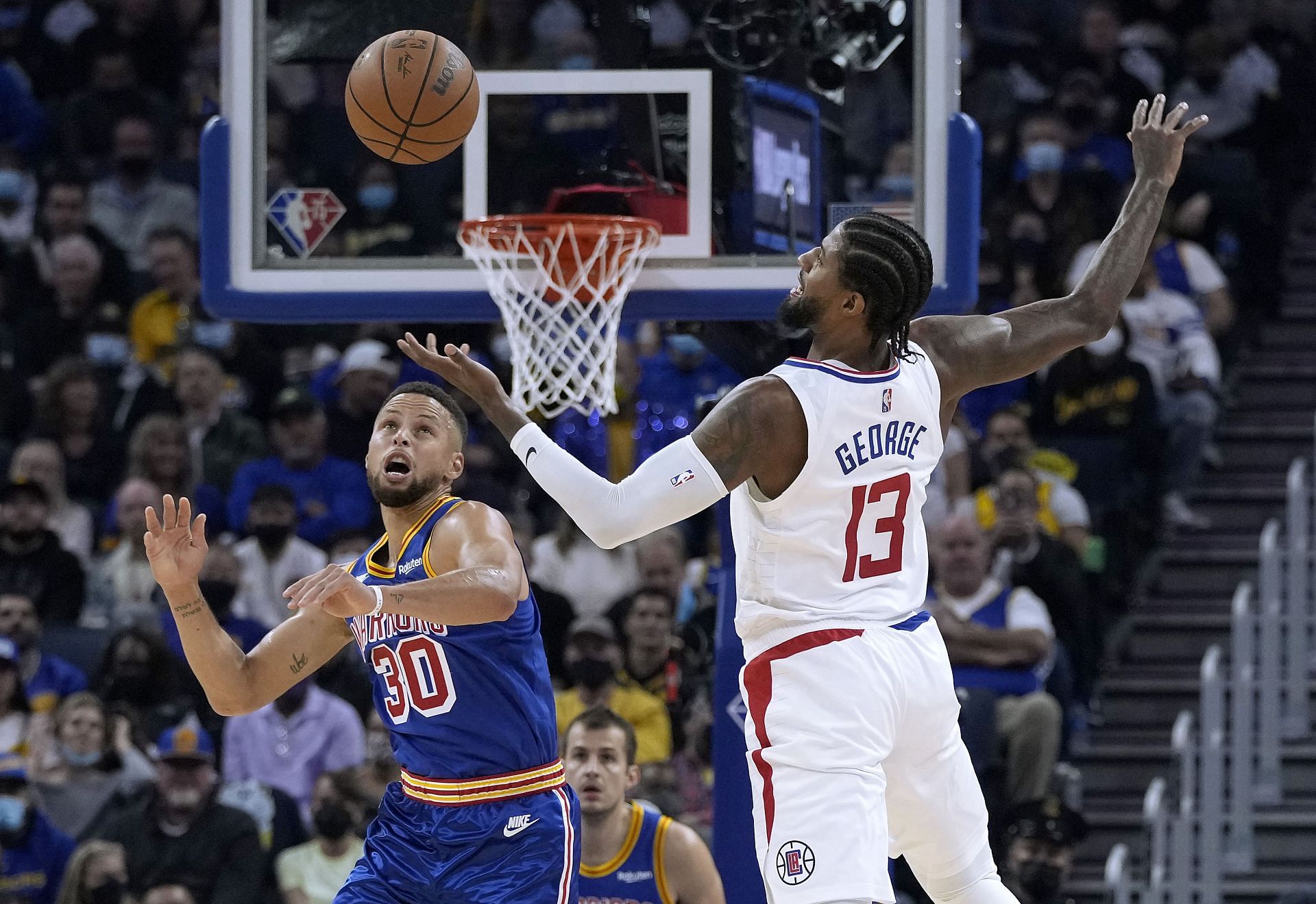 Stephen Curry of the Golden State Warriors steals the ball from Paul George of the LA Clippers