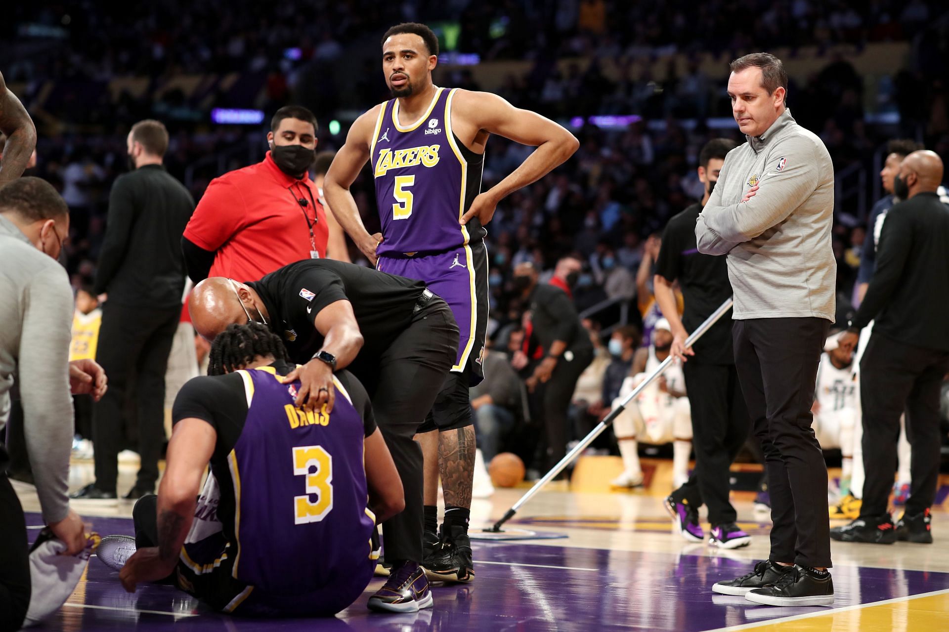 Talen Horton-Tucker (5) and coach Frank Vogel of the LA Lakers check up on Anthony Davis after an injury during the second quarter against the Utah Jazz on Wednesday in Los Angeles, California.