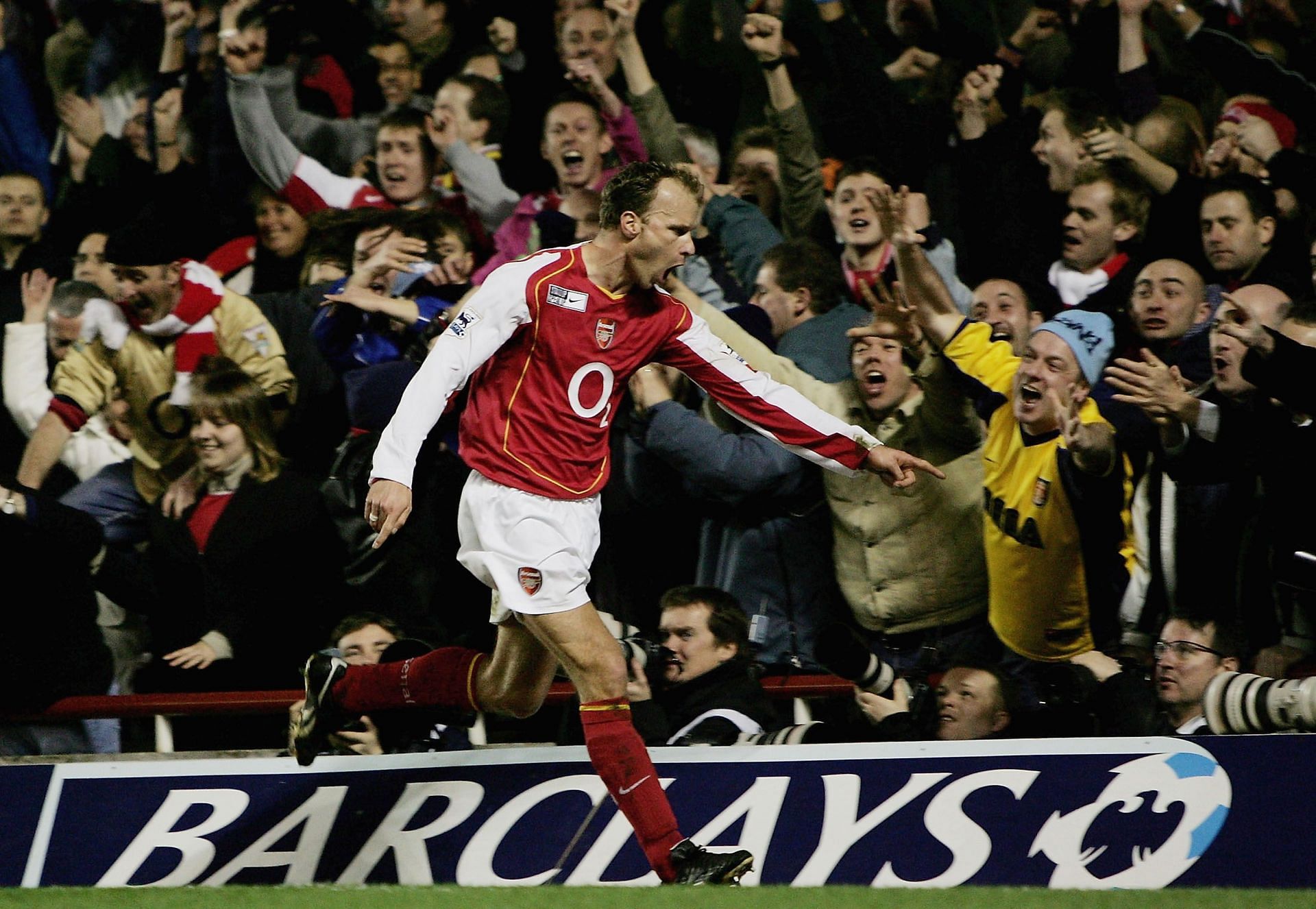 Bergkamp celebrates after scoring against Manchester United