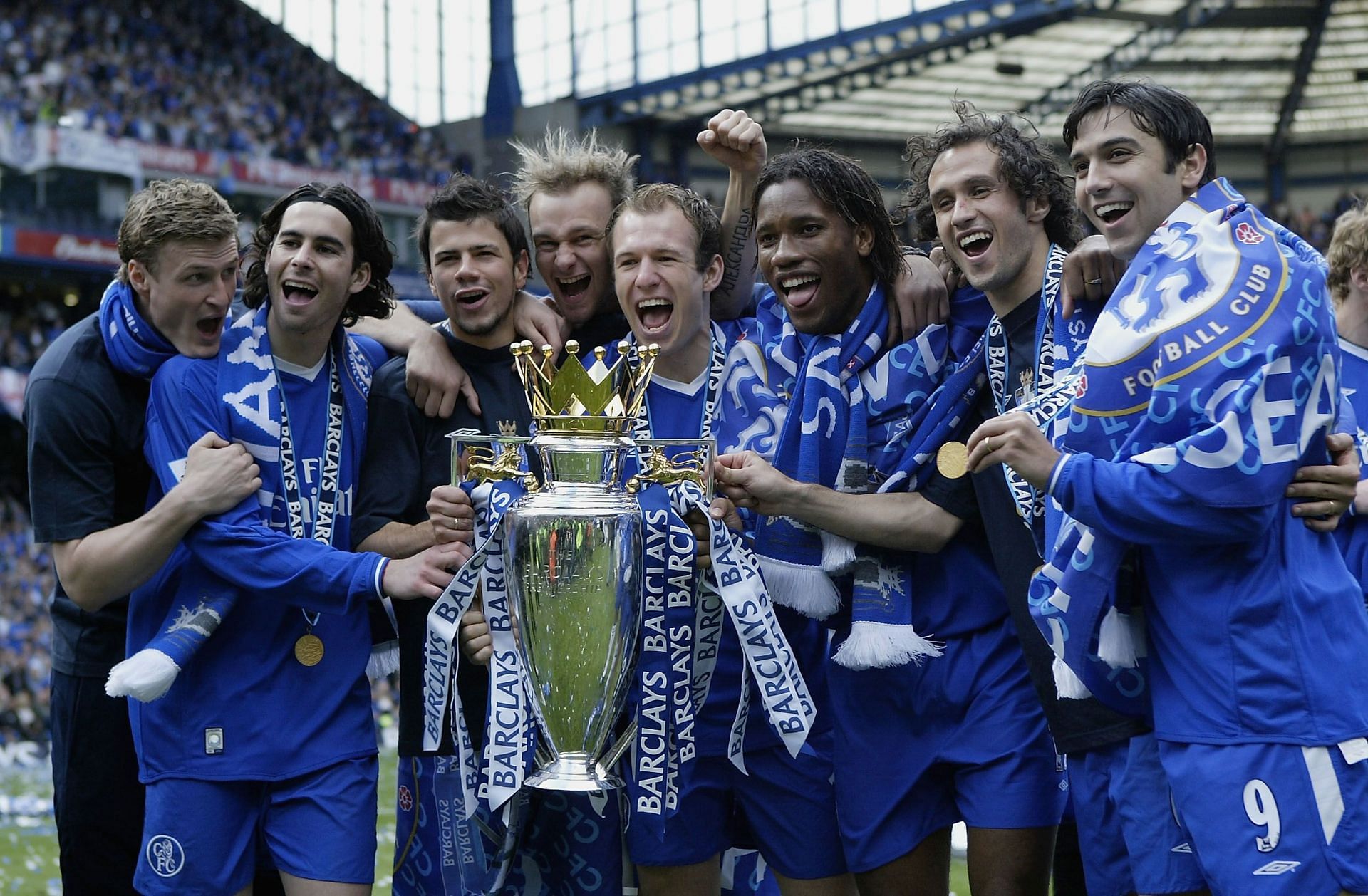 Chelsea players celebrating with the Premier League trophy