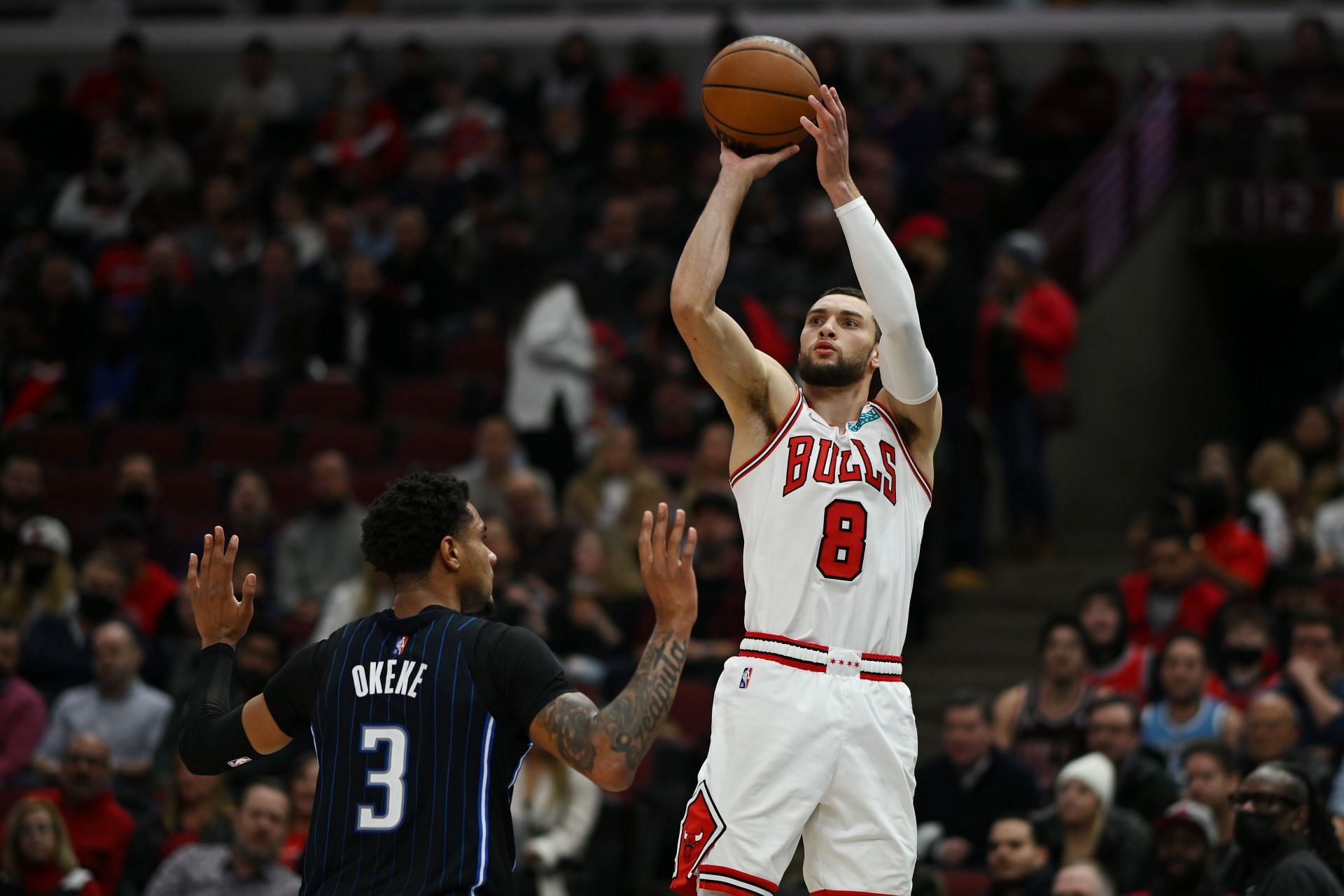 Zach LaVine #8 of the Chicago Bulls shoots a three point basket against Chuma Okeke #3 of the Orlando Magic