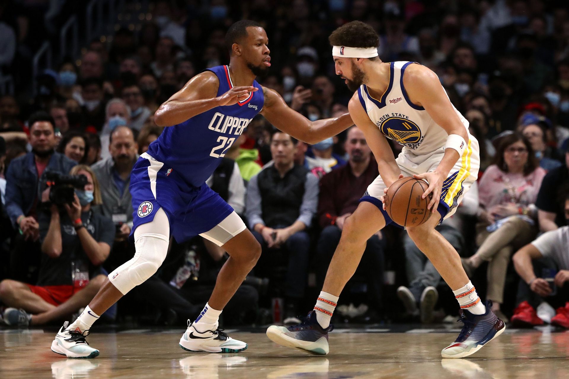 Klay Thompson, #11 of the Golden State Warriors, handles the ball against Rodney Hood, #22 of the Los Angeles Clippers, during the second quarter at Crypto.com Arena on February 14, 2022 in Los Angeles, California.