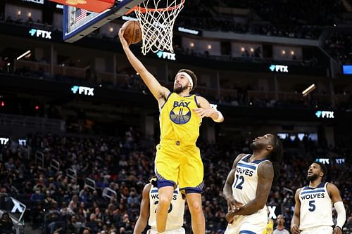 Klay Thompson, #11 of the Golden State Warriors, goes up for the layup against Taurean Prince, #12 of the Minnesota Timberwolves, at Chase Center on January 27, 2022 in San Francisco, California.