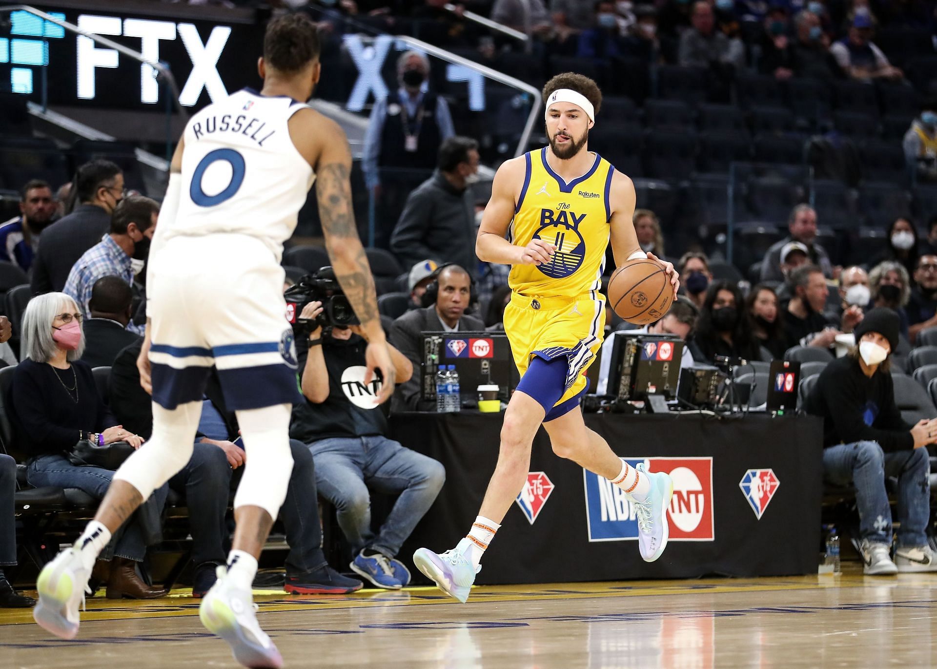 Klay Thompson #11 of the Golden State Warriors dribbles up the court with the ball against DAngelo Russell #0 of the Minnesota Timberwolves