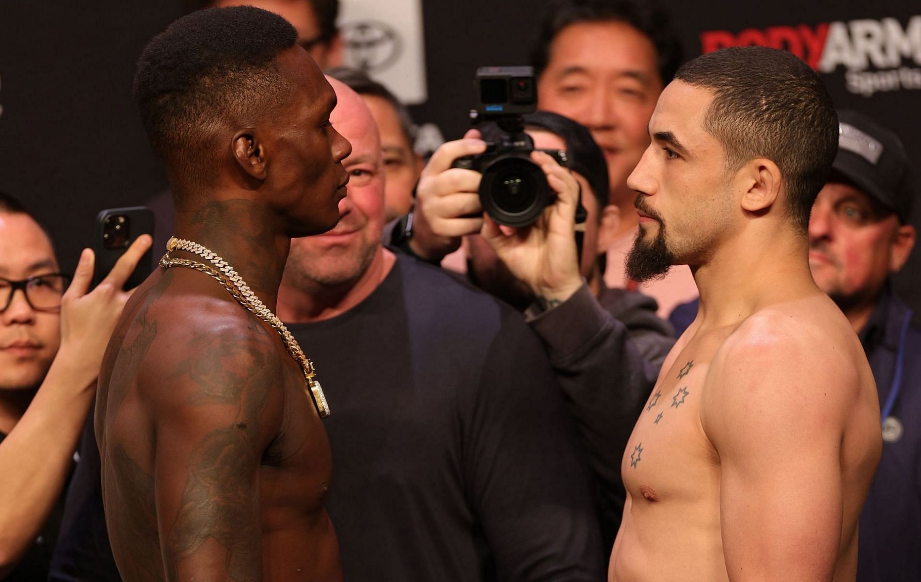 Israel Adesanya (left) &amp; Robert Whittaker (right)