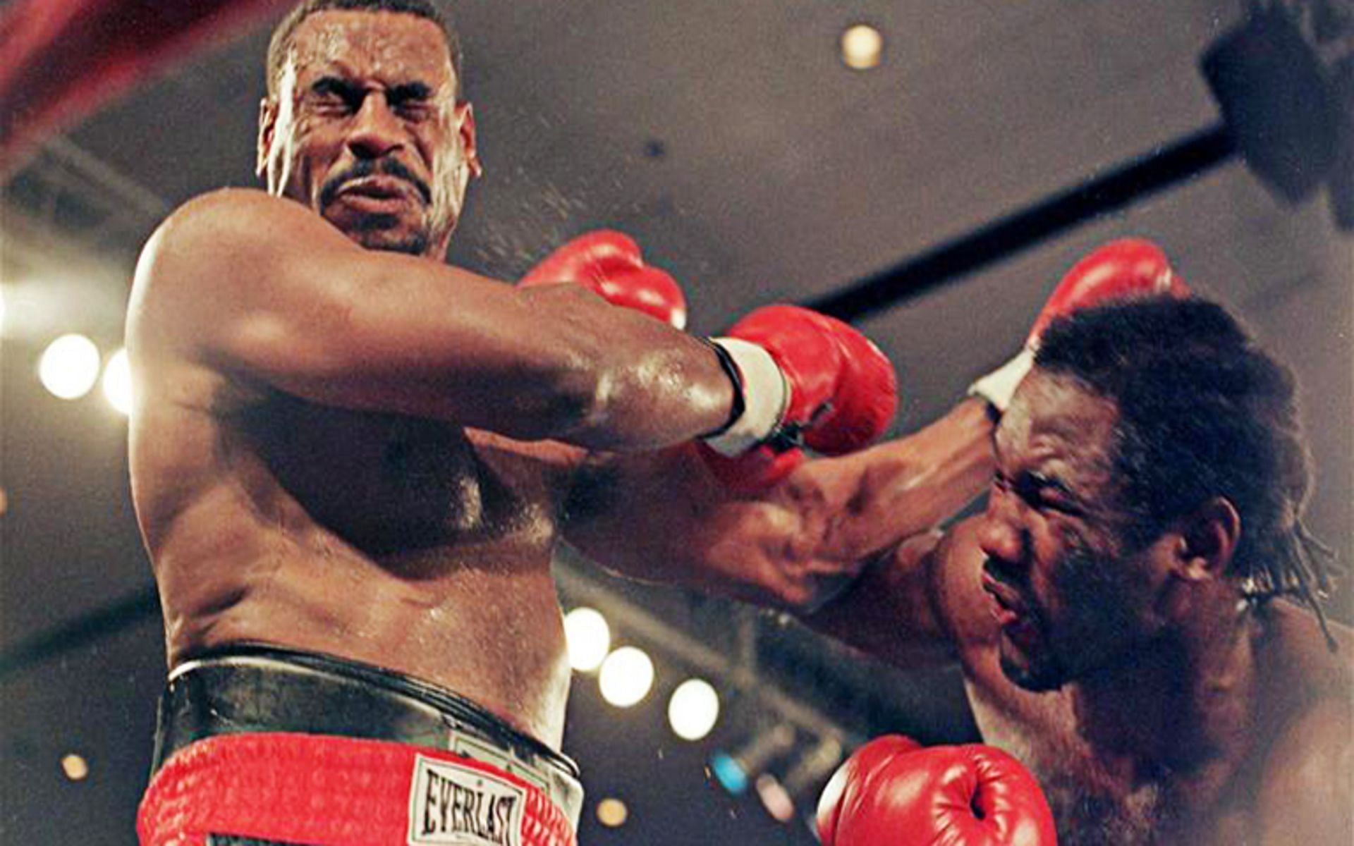Oliver McCall (L) broke down and lost to Lennox Lewis (R) on this day in 1997