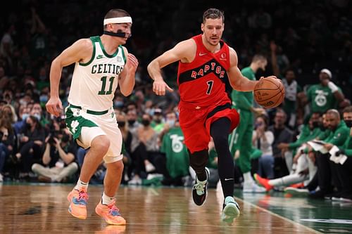 Goran Dragic of the Toronto Raptors dribbles against Payton Pritchard of the Boston Celtics during the Celtics home opener at TD Garden on Oct. 22 in Boston, Massachusetts.