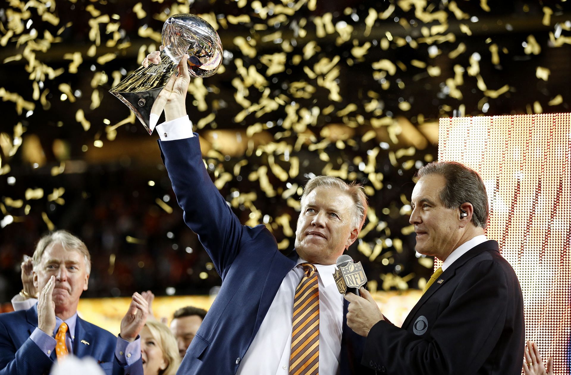 John Elway lifting the Vince Lombardi Trophy