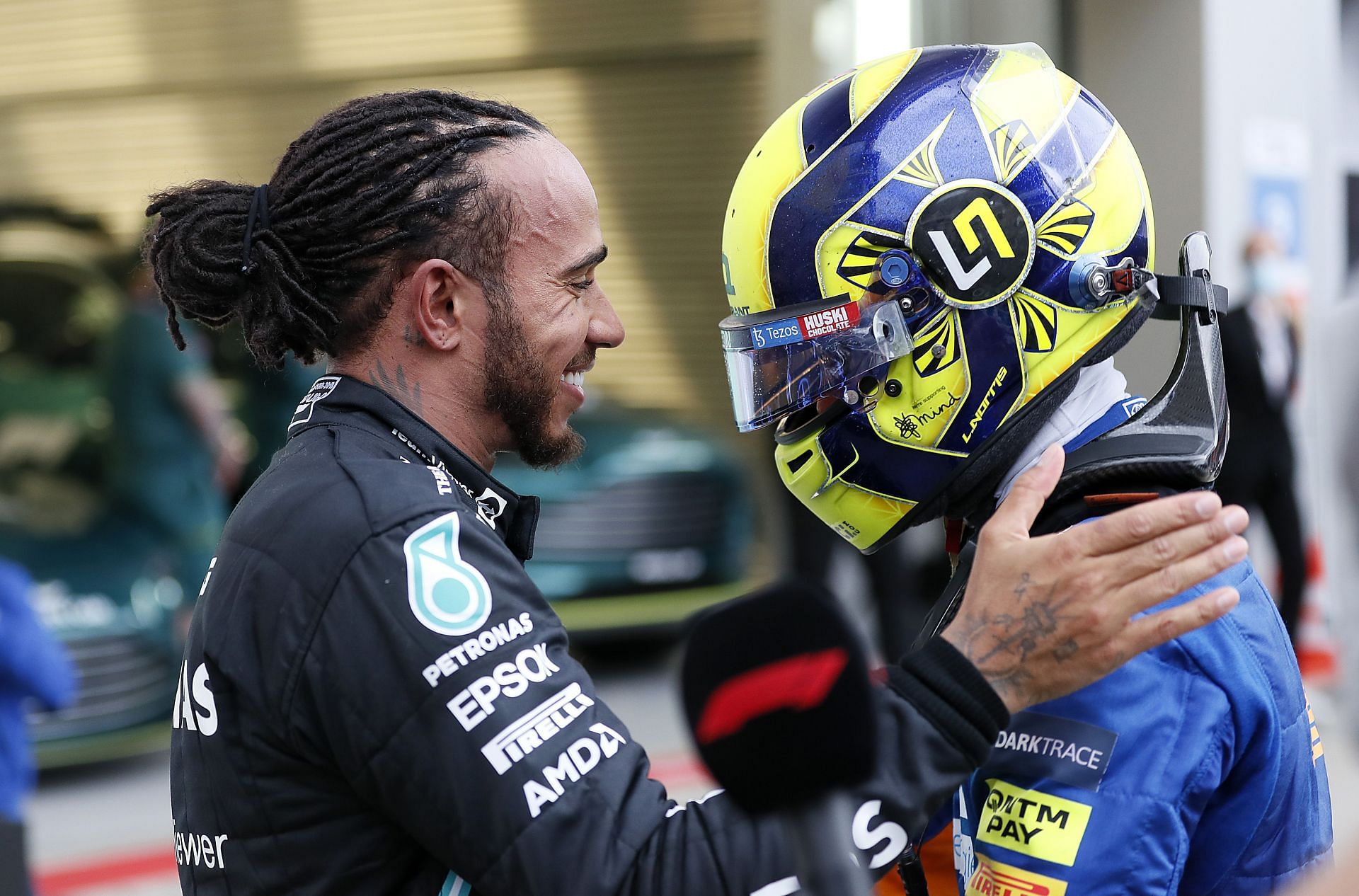 Lewis Hamilton (left) comforts Lando Norris (right) after the latter&#039;s disappointment at the 2021 Russian Grand Prix