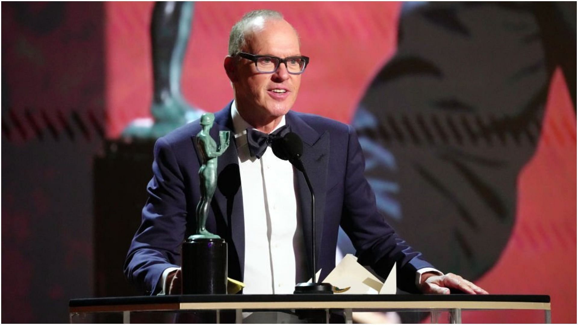 Michael Keaton accepts the award for Outstanding Performance by a Male Actor in a Television Movie or Limited Series for &quot;Dopesick&quot; during the 28th Screen Actors Guild Awards (Image via Kevin Mazur/Getty Images)