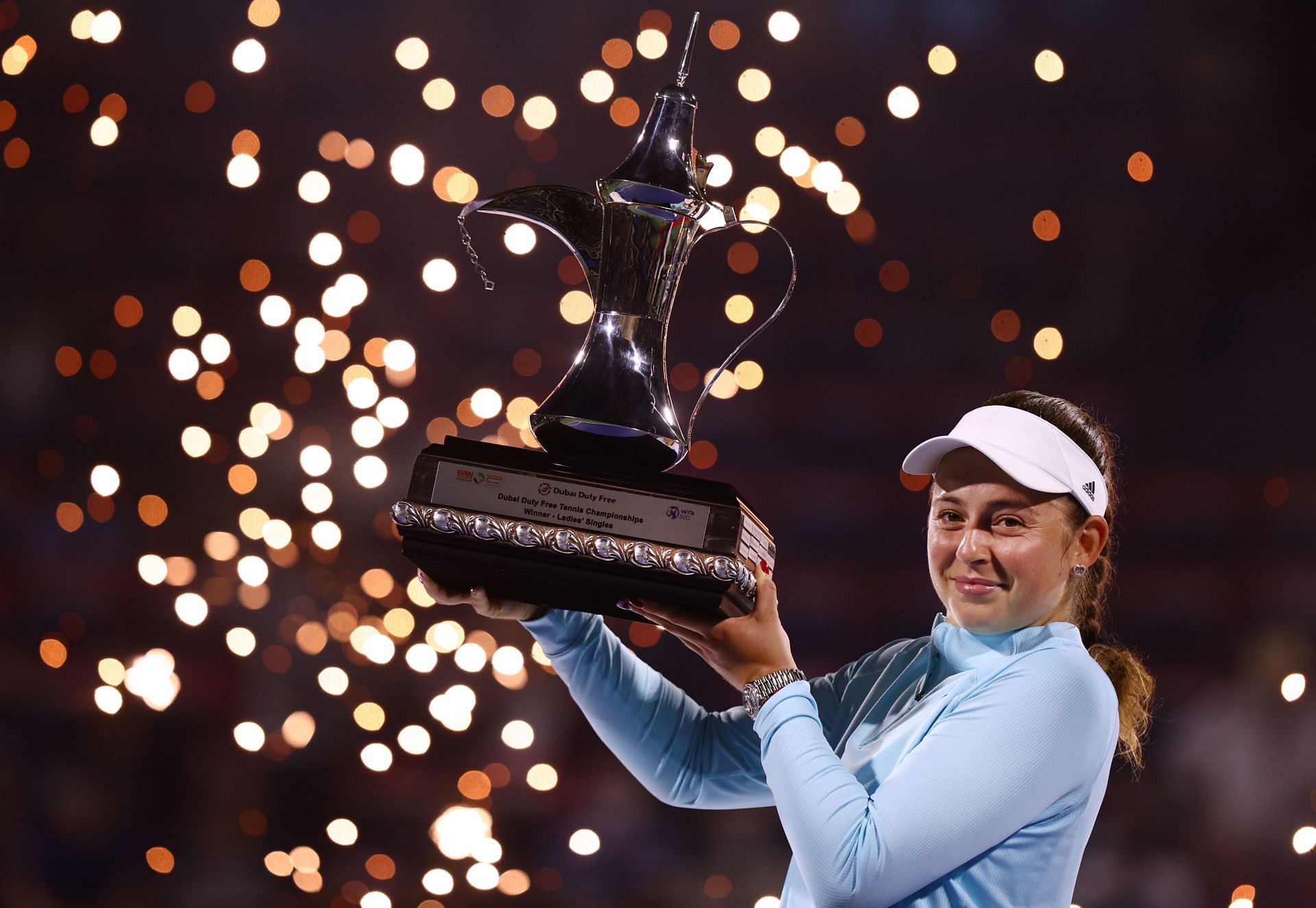 Jelena Ostapenko celebrates with the trophy after winning the Dubai Duty Free Tennis Championships.