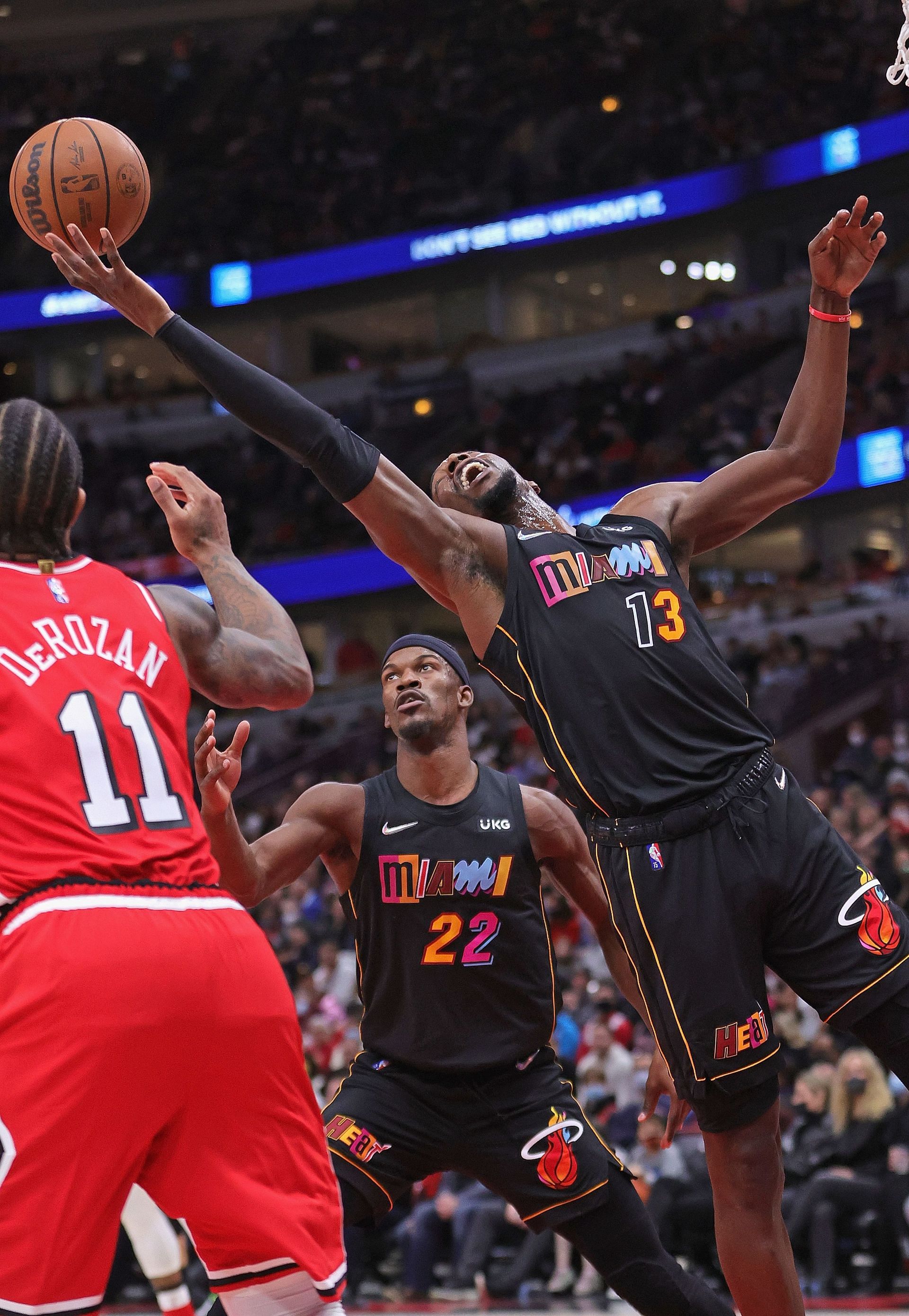 Miami Heat vs. Chicago Bulls: Miami&#039;s Bam Adebayo rebounds over DeMar DeRozan.