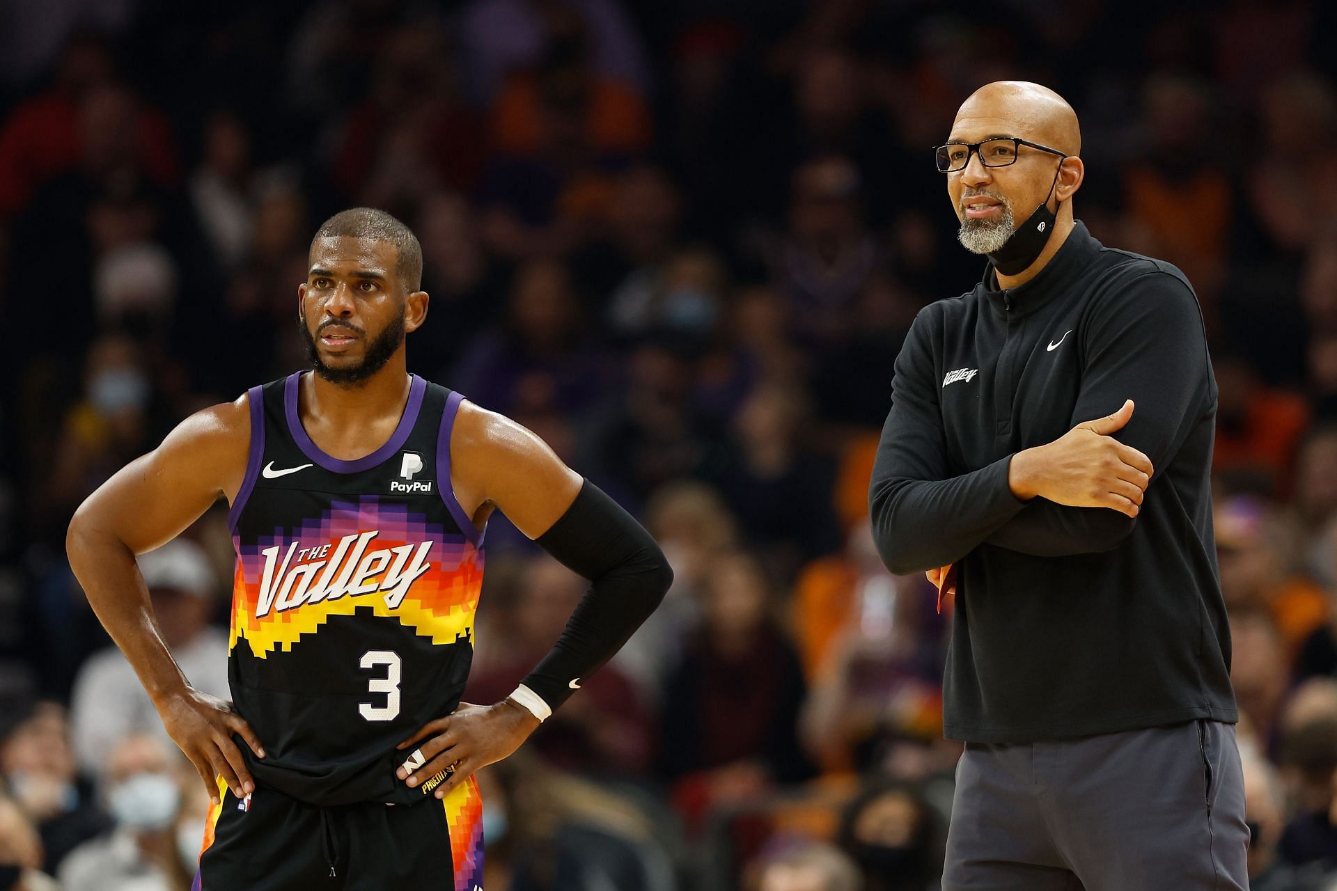 Coach Monty Williams of the Phoenix Suns talks with Chris Paul.