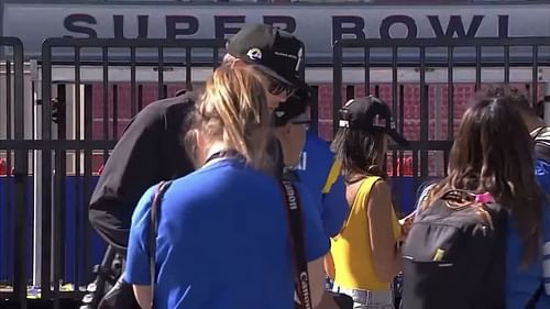 Rams QB Matthew Stafford and an NFL photographer who later fell off the stage at the Rams' victory parade. (screenshot via @PardonMyTake)