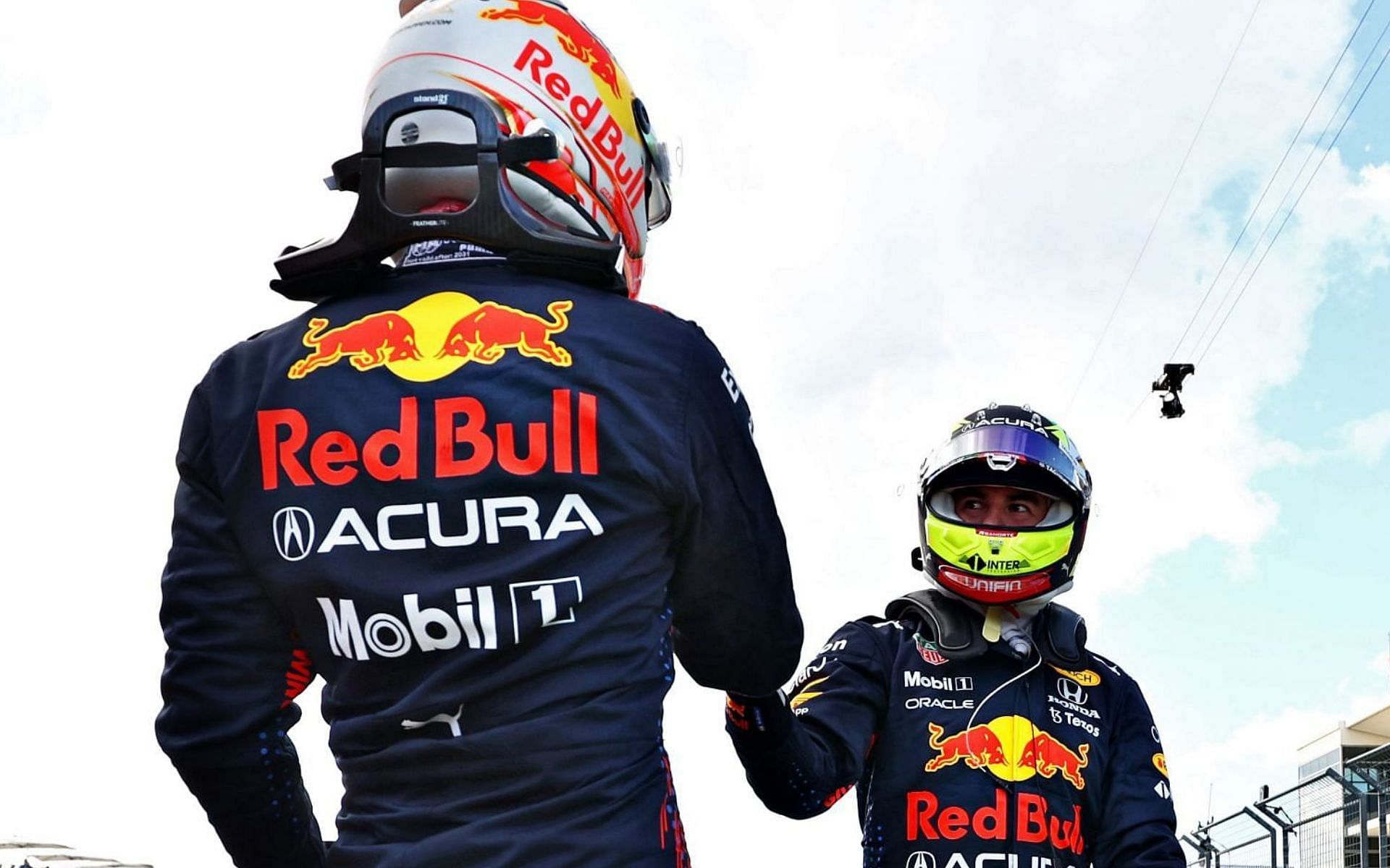 Max Verstappen (left) and Sergio Perez (right) congratulate each other after locking out the front row for the 2021 United States Grand Prix