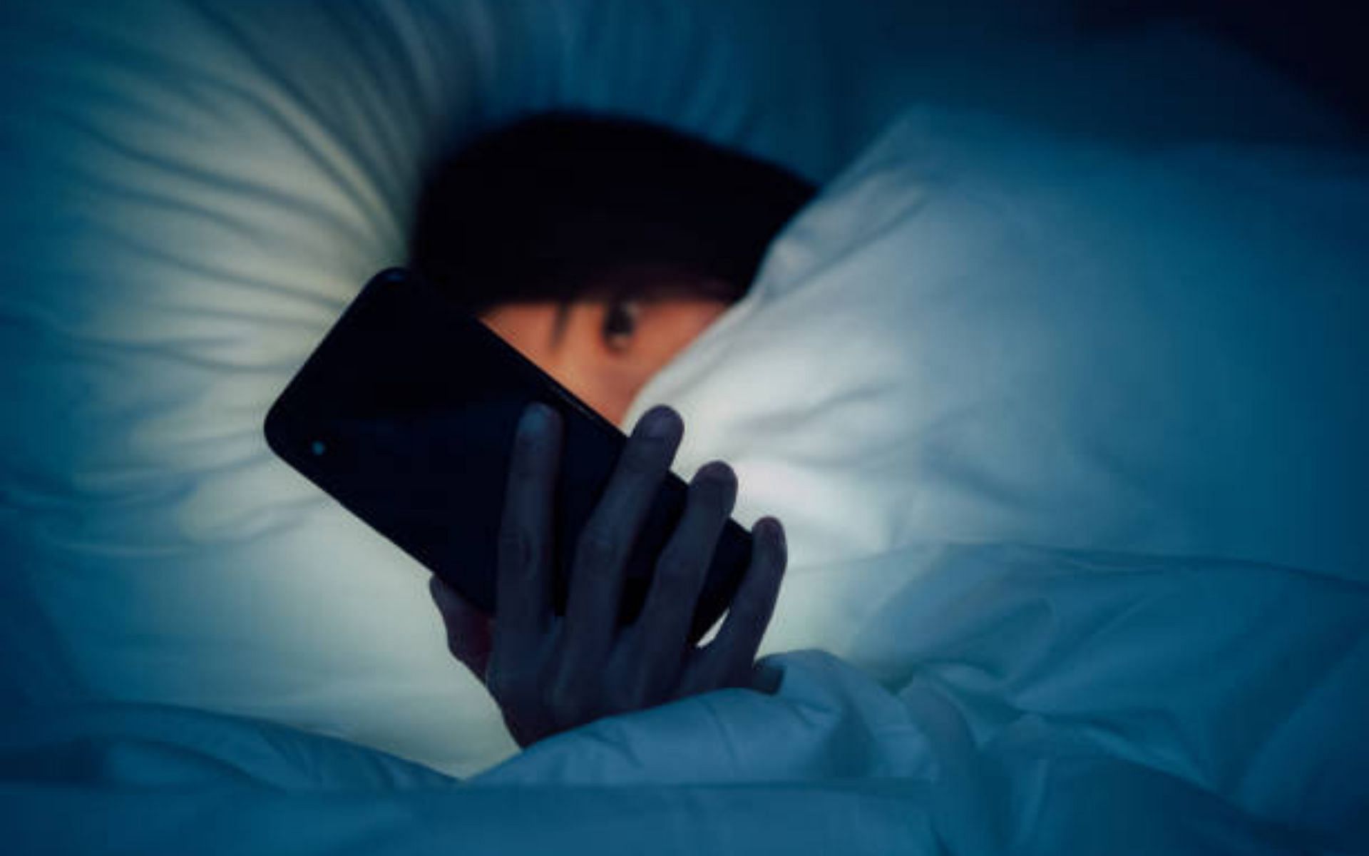 Staying completely tucked in under covers to stop scary things from getting to you (Image via Getty Images)