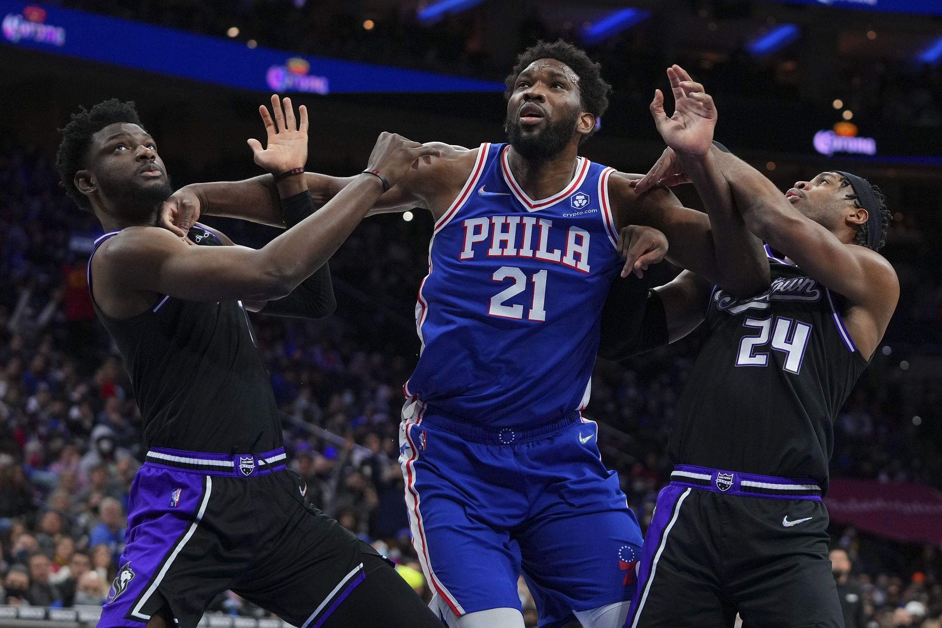 Chimezie Metu n(left) and Buddy Hield (24) of the Sacramento Kings attempt to box out Joel Embiid of the Philadelphia 76ers