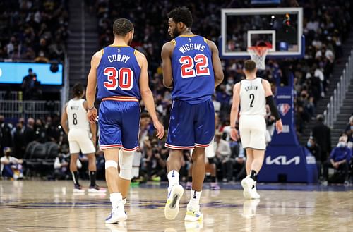 Brooklyn Nets v Golden State Warriors; Steph Curry and Andrew Wiggins talking after a play