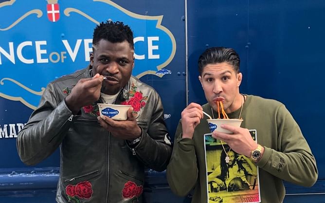 Watch: Brendan Schaub gifts Francis Ngannou Nike x Sacai VaporWaffle sneakers paying homage to the Cameroonian flag