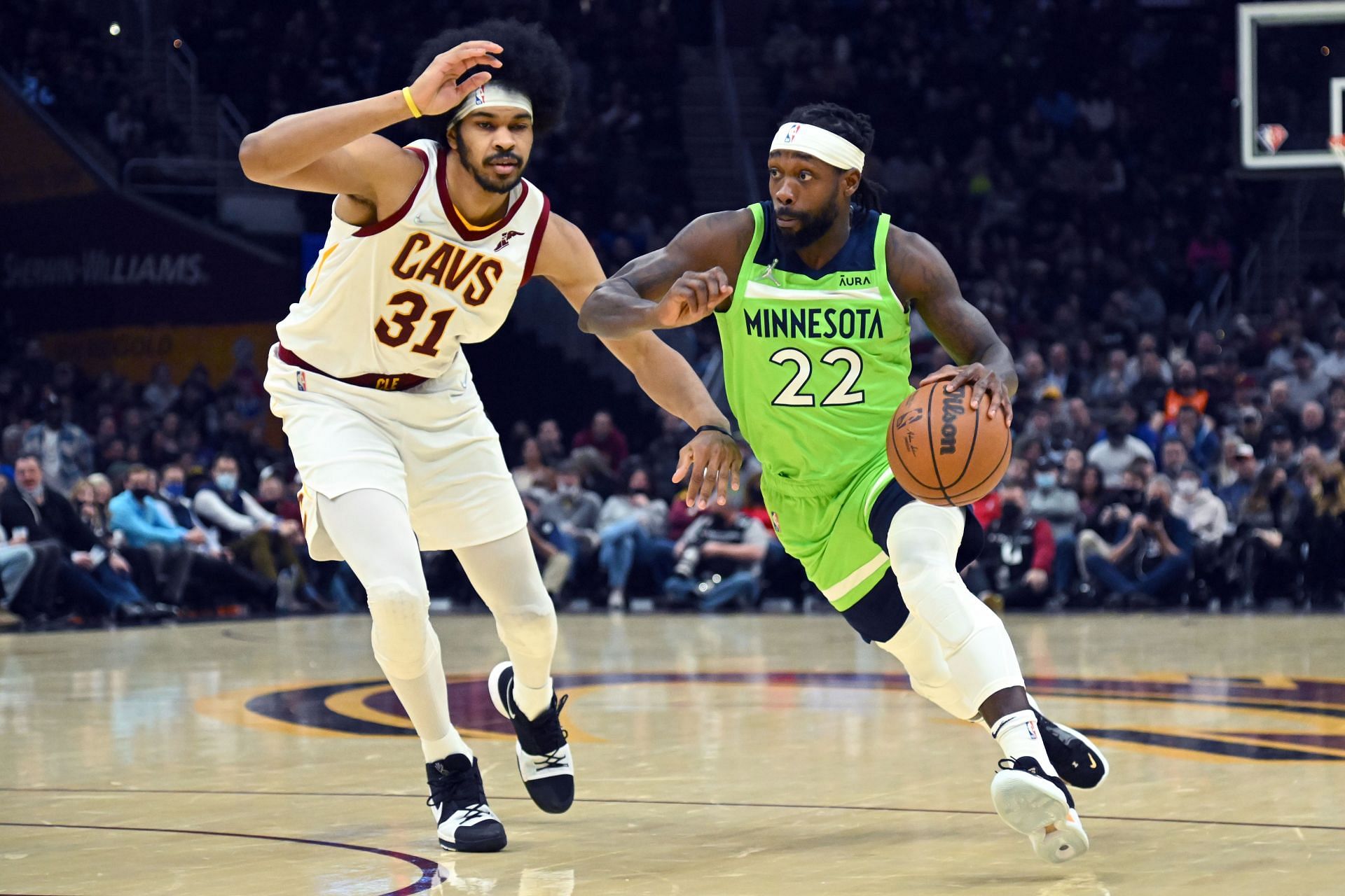 Minnesota Timberwolves guard Patrick Beverley drives around Jarrett Allen of the Cleveland Cavaliers.