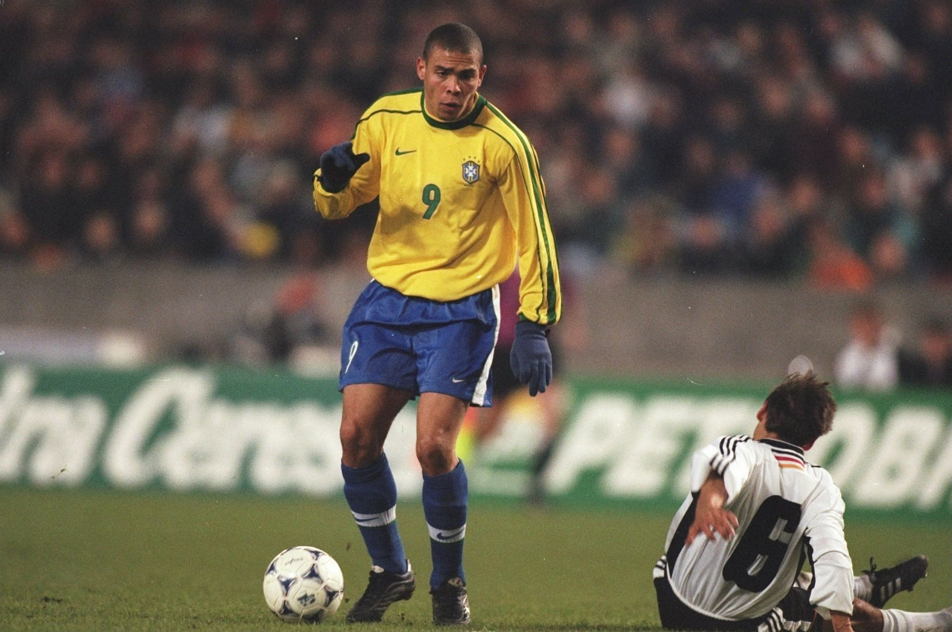 Ronaldo of Brazil and Olaf Thon of Germany in action