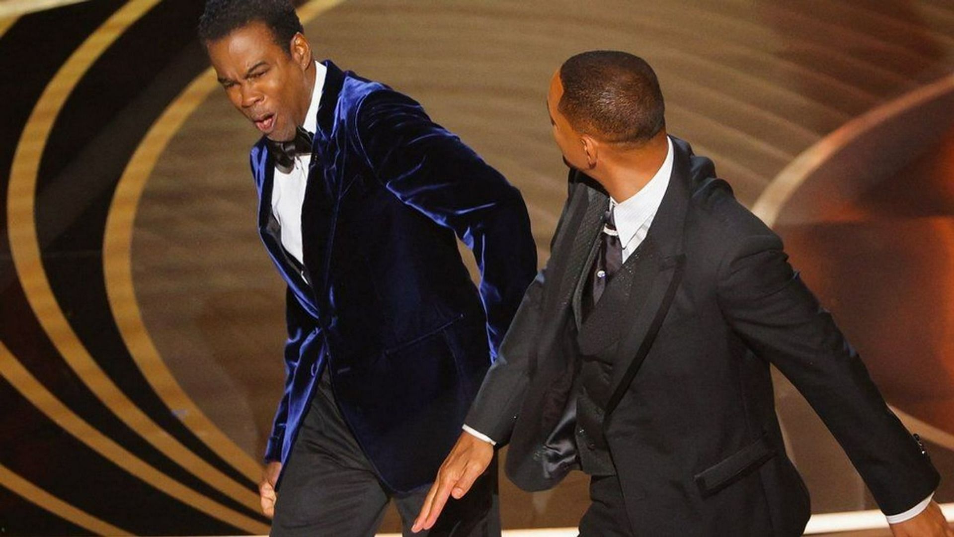 Will Smith punches Chris Rock during Oscars live ceremony (Image via Getty Images)