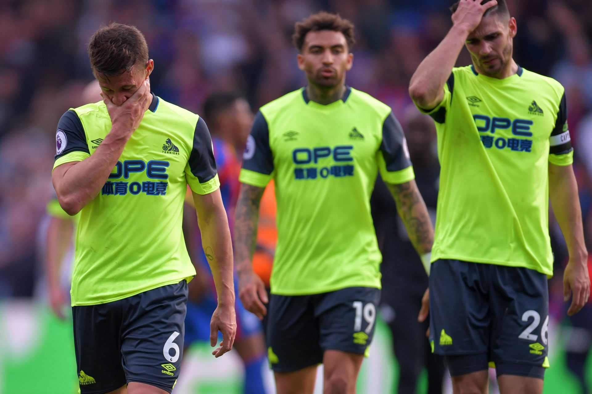 Huddersfield players react after losing to Crystal Palace