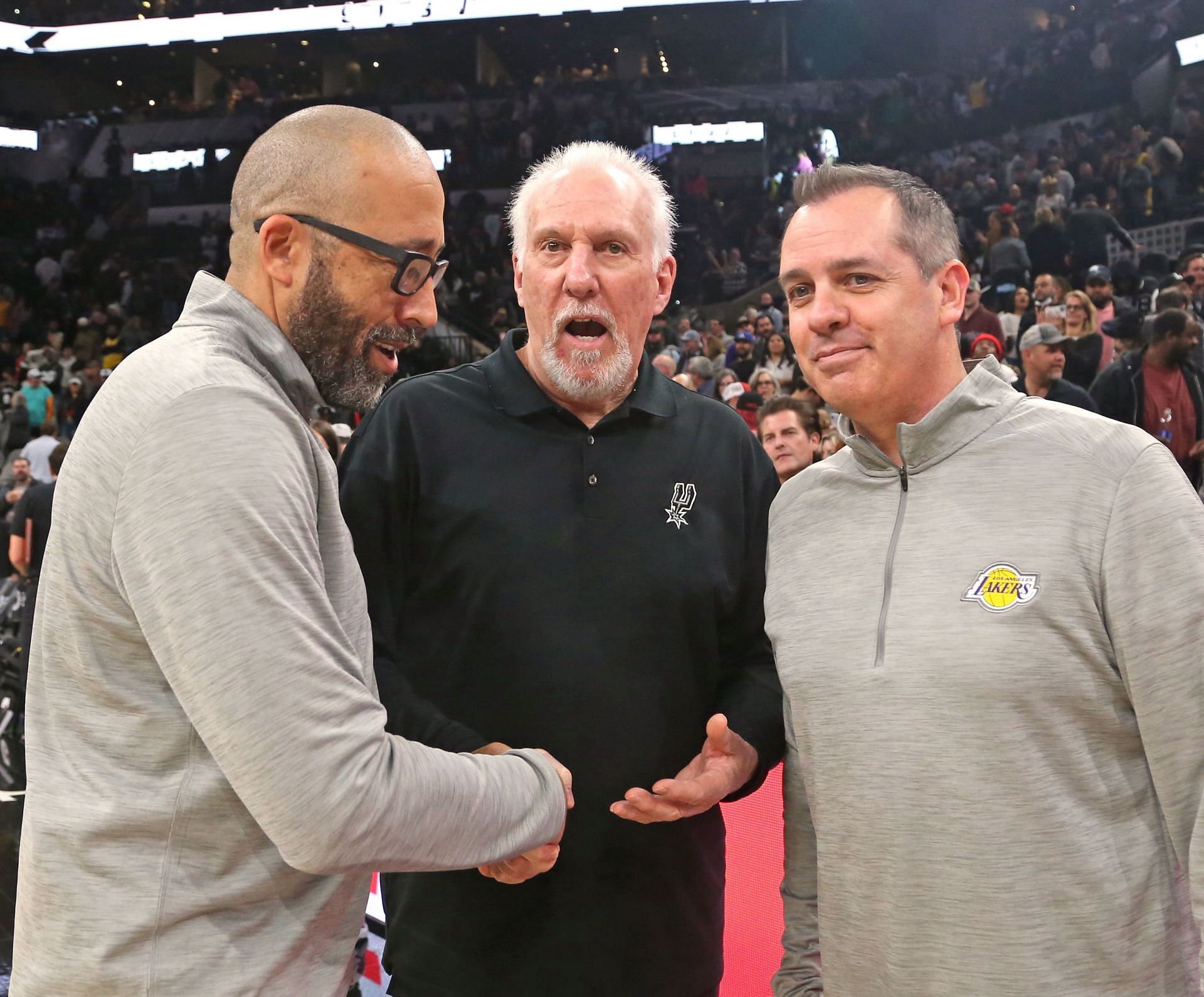 Head coach Gregg Popovich of the San Antonio Spurs is congratulated by head coach Frank Vogel (R) and assistant coach David Fizdale (L) of the LA Lakers after Popovich tied the NBA record for all-time wins of 1,335 by an NBA head coach after the San Antonio Spurs defeated the Los Angeles Lakers 117-110 at AT&amp;T Center on March 7, 2022 in San Antonio, Texas.