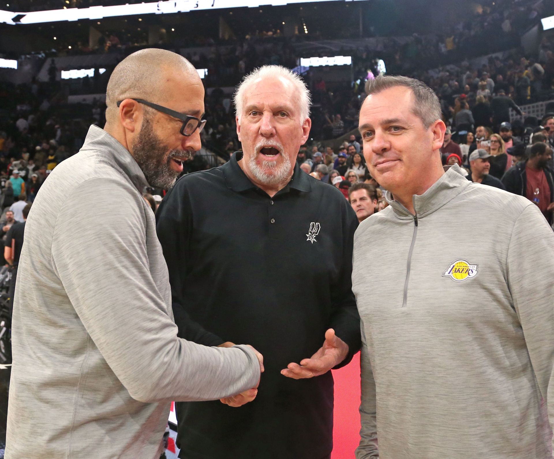 Head coach Gregg Popovich of the San Antonio Spurs is congratulated by head coach Frank Vogel (R) and assistant coach David Fizdale (L) of the LA Lakers after Popovich tied the NBA record for all-time wins of 1,335 by an NBA head coach after the San Antonio Spurs defeated the Los Angeles Lakers 117-110 at AT&T Center on March 7, 2022 in San Antonio, Texas.