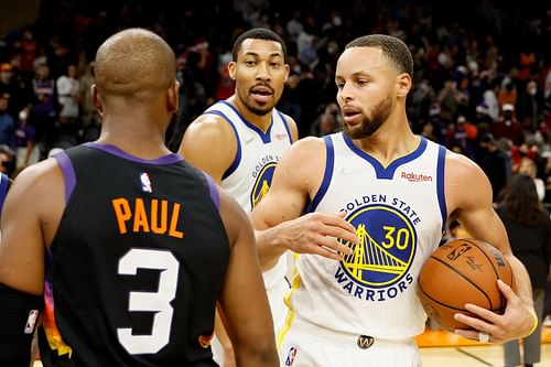 Stephen Curry and Otto Porter Jr. of the Golden State Warriors greet Chris Paul of the Phoenix Suns