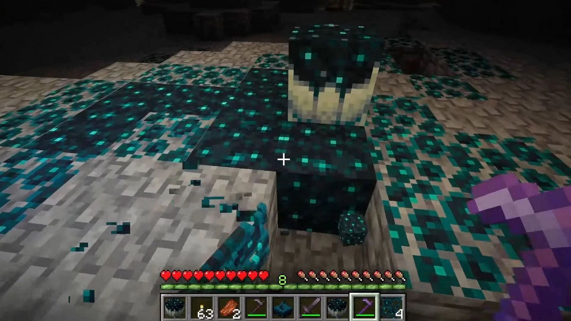 Sculk veins growing around solid sculk blocks (Image via Mojang)