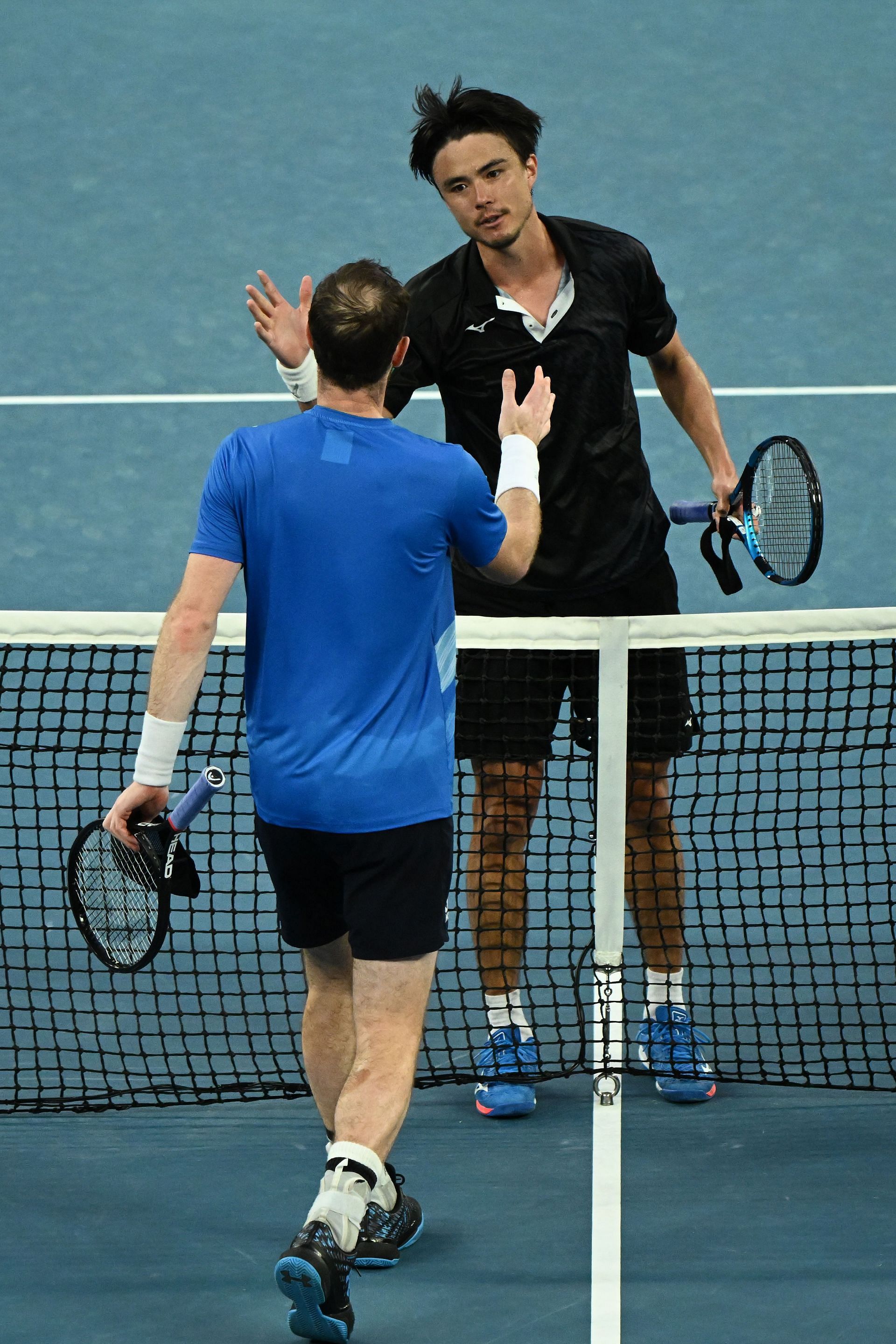Andy Murray and Taro Daniel at the net following their second-round match at the 2022 Australian Open