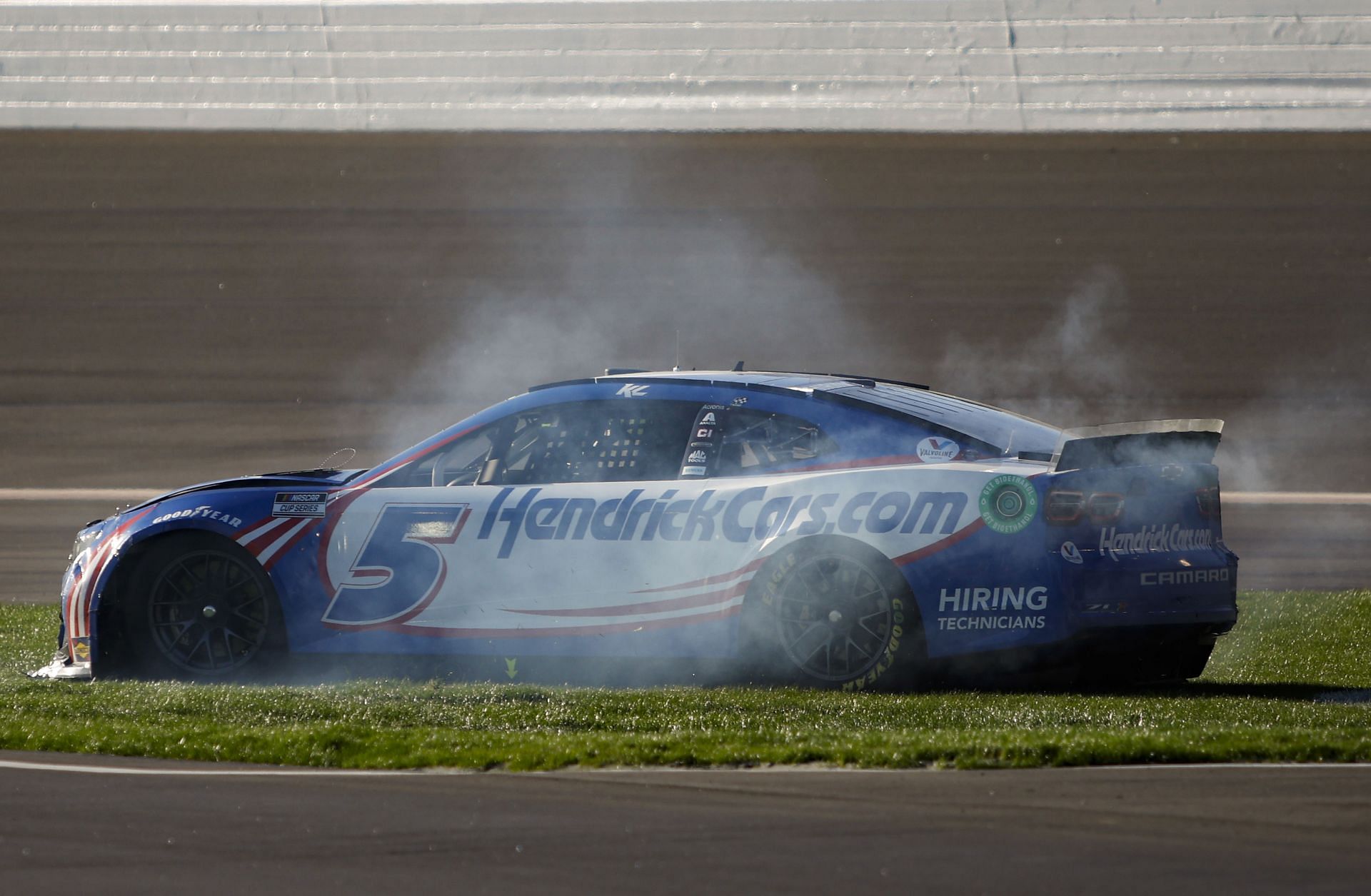 Kyle Larson spins into the infield grass after an on-track incident during the NASCAR Cup Series Folds of Honor QuikTrip 500.