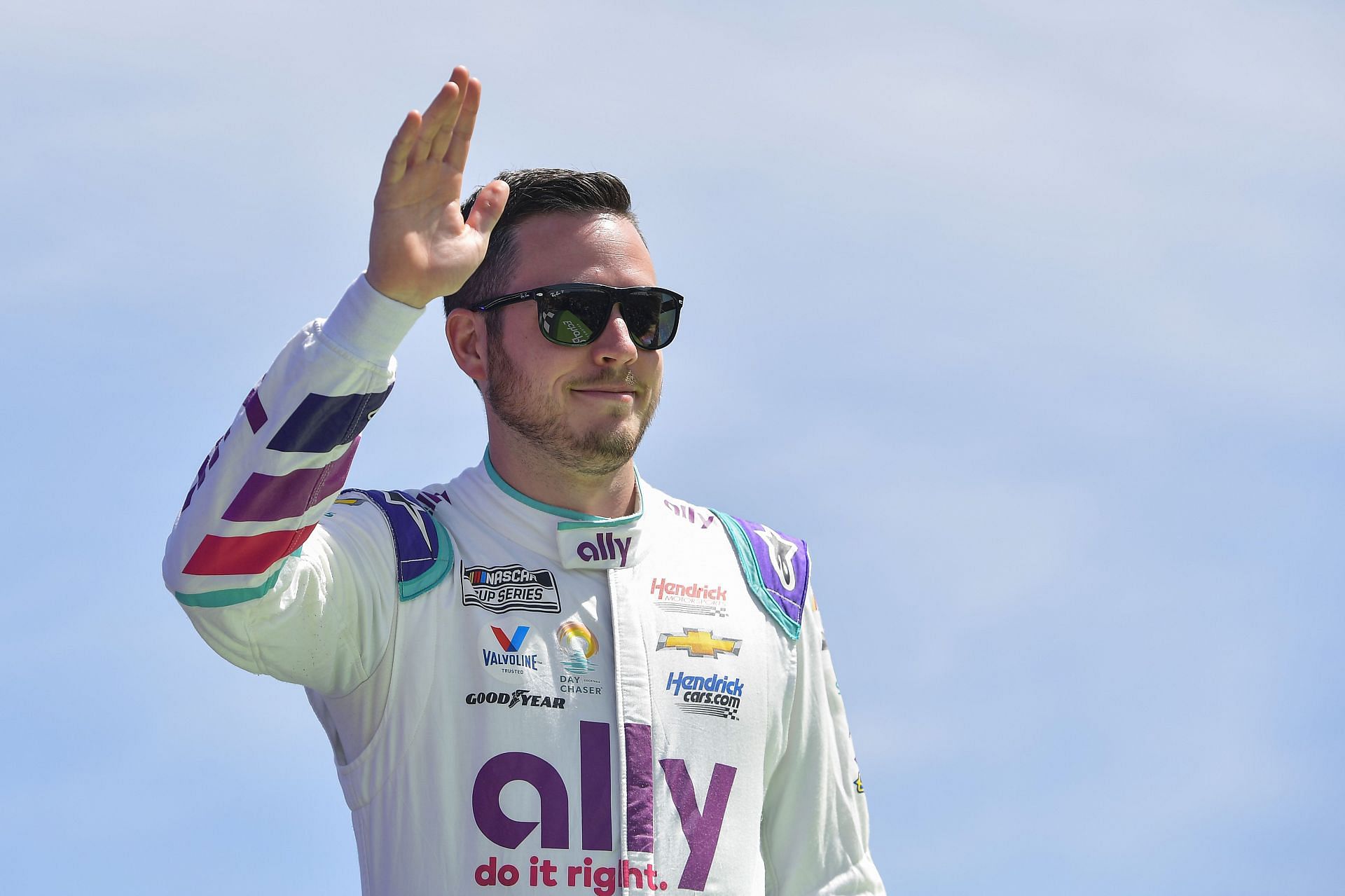 Alex Bowman waves to fans onstage during driver intros prior to the NASCAR Cup Series Echopark Automotive Grand Prix.