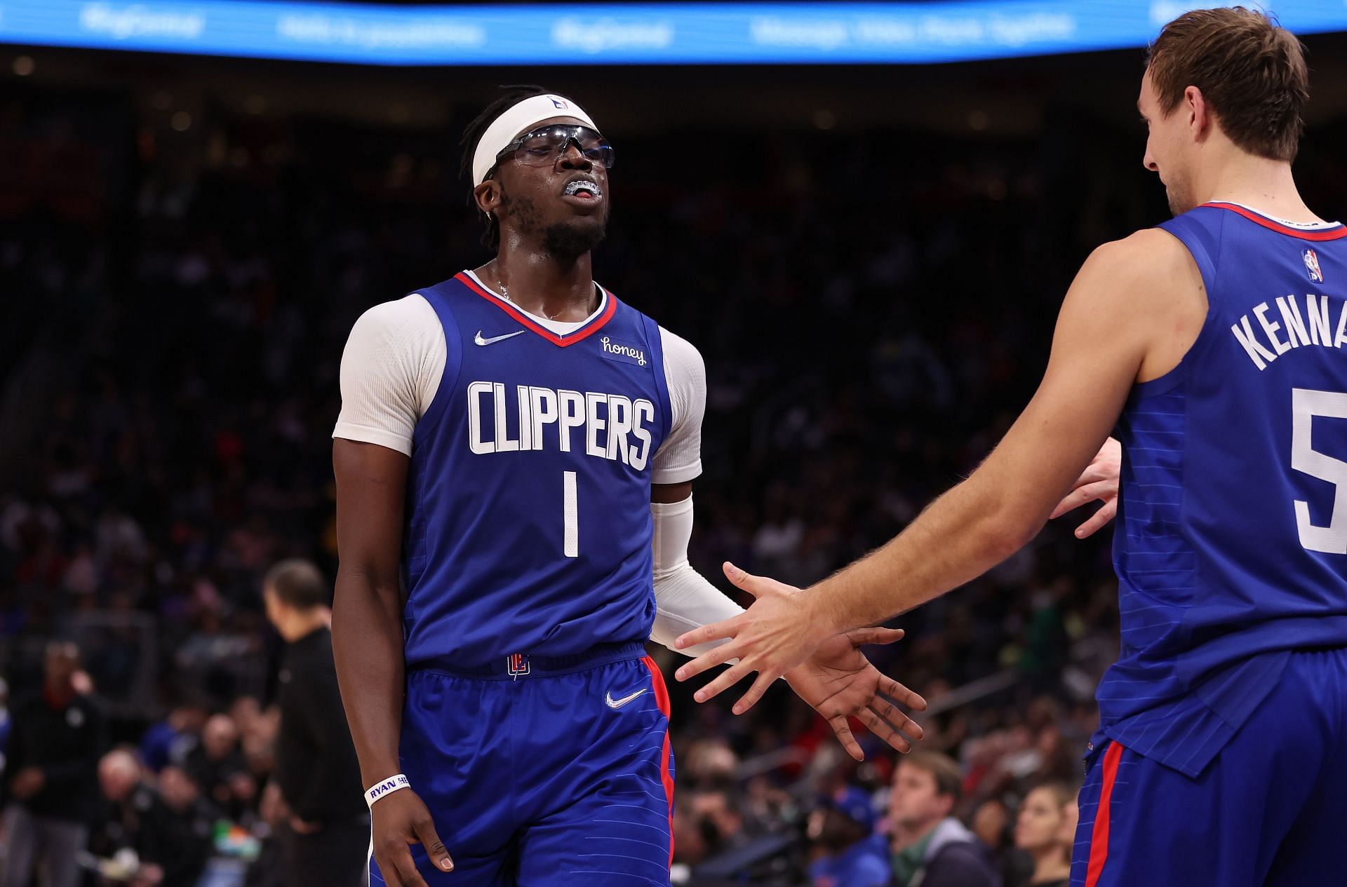 Reggie Jackson celerates a play with LA Clippers' teammates