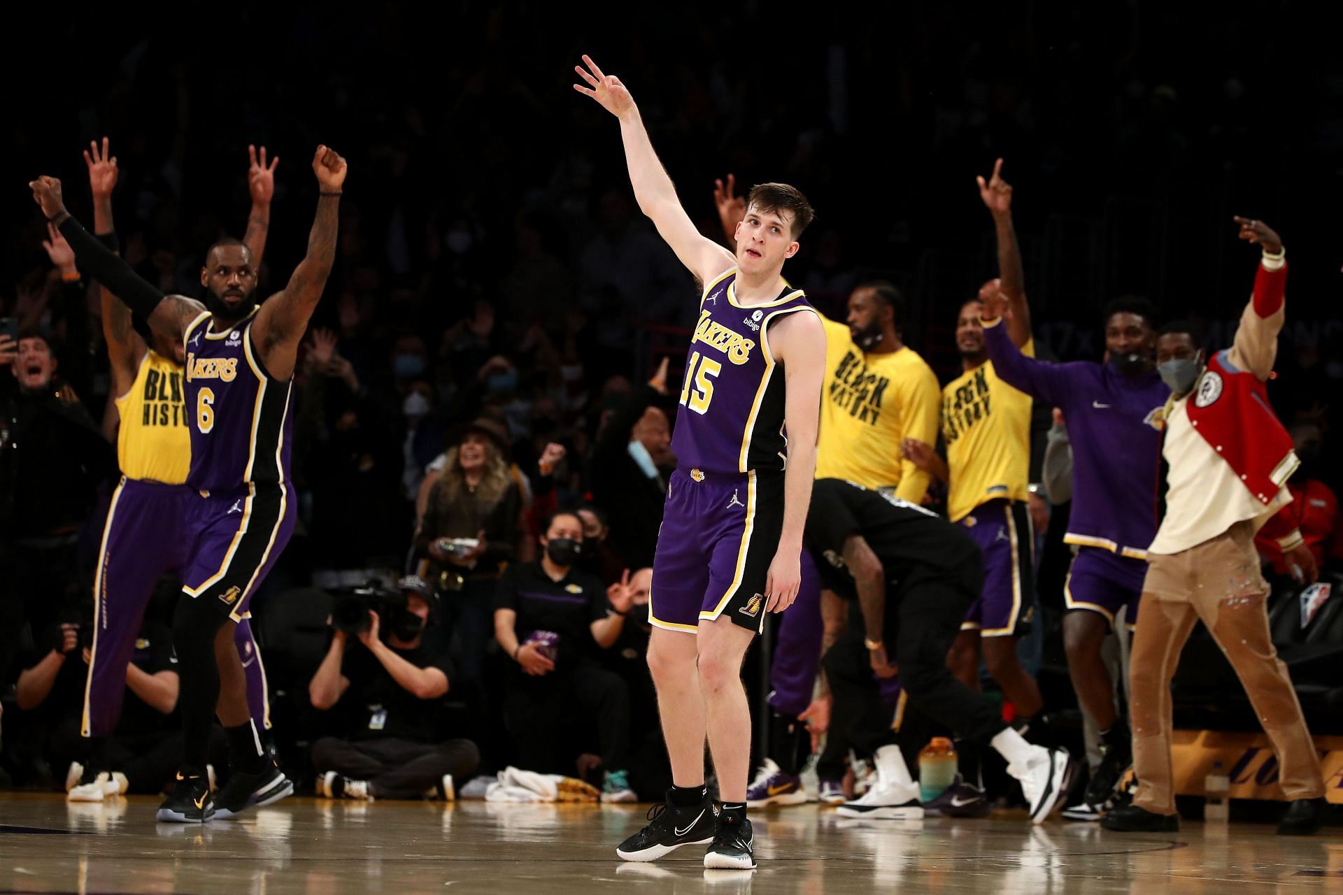 Austin Reaves #15 and the LA Lakers react after a 3-point basket
