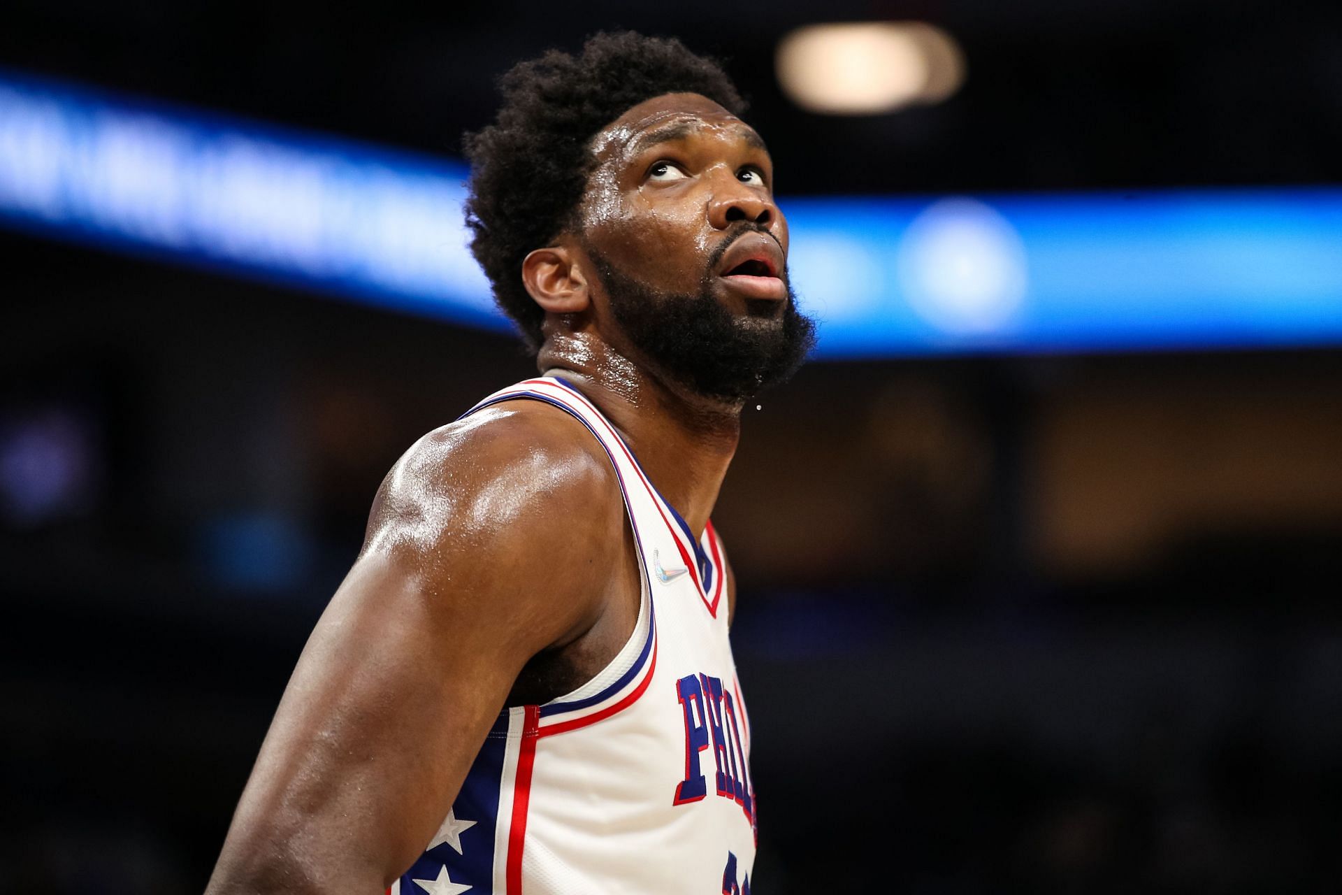 Joel Embiid looks on at a 76ers game